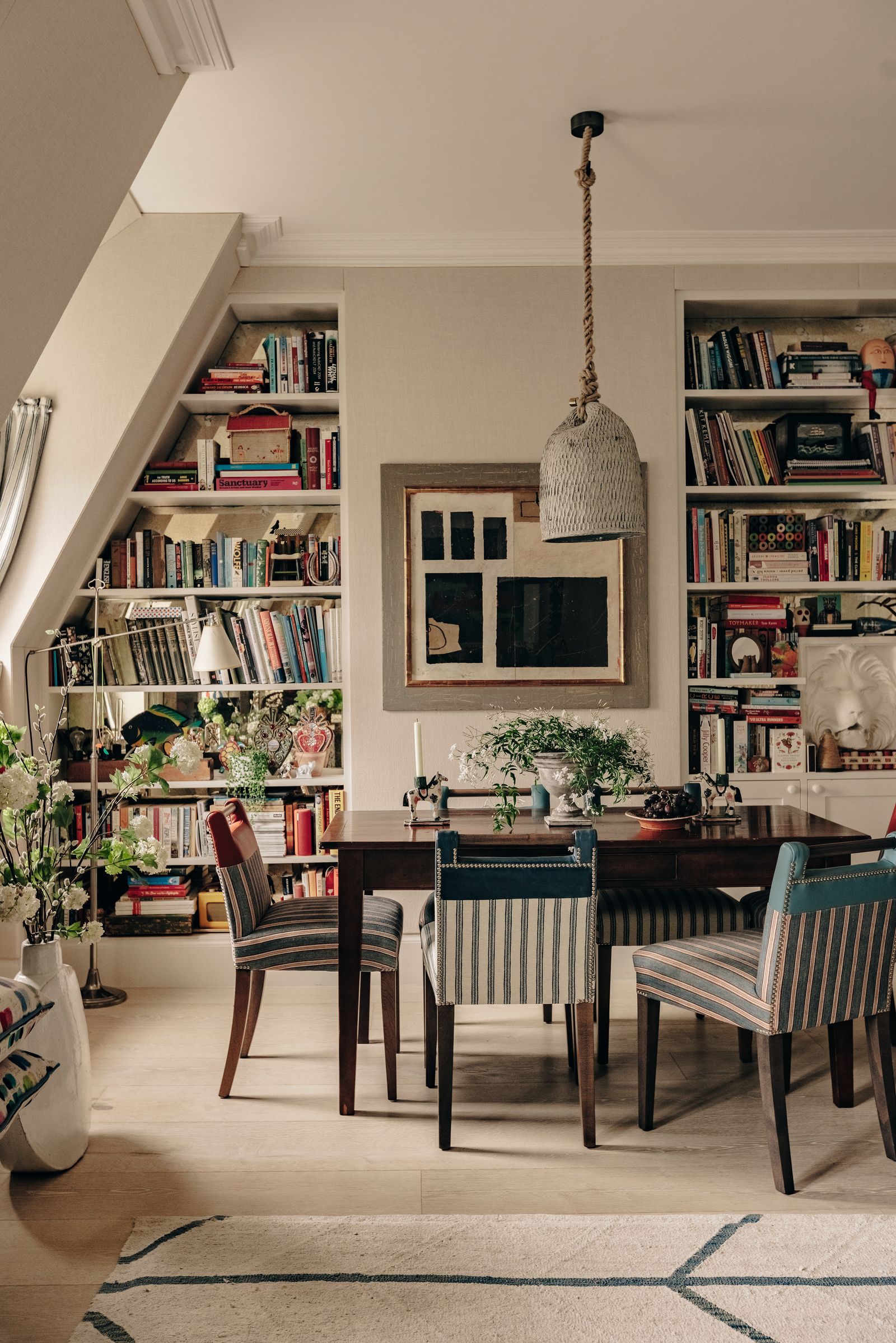 Image may contain Chair Furniture Plant Bookcase Lamp Desk Table Home Decor Rug Architecture and Building