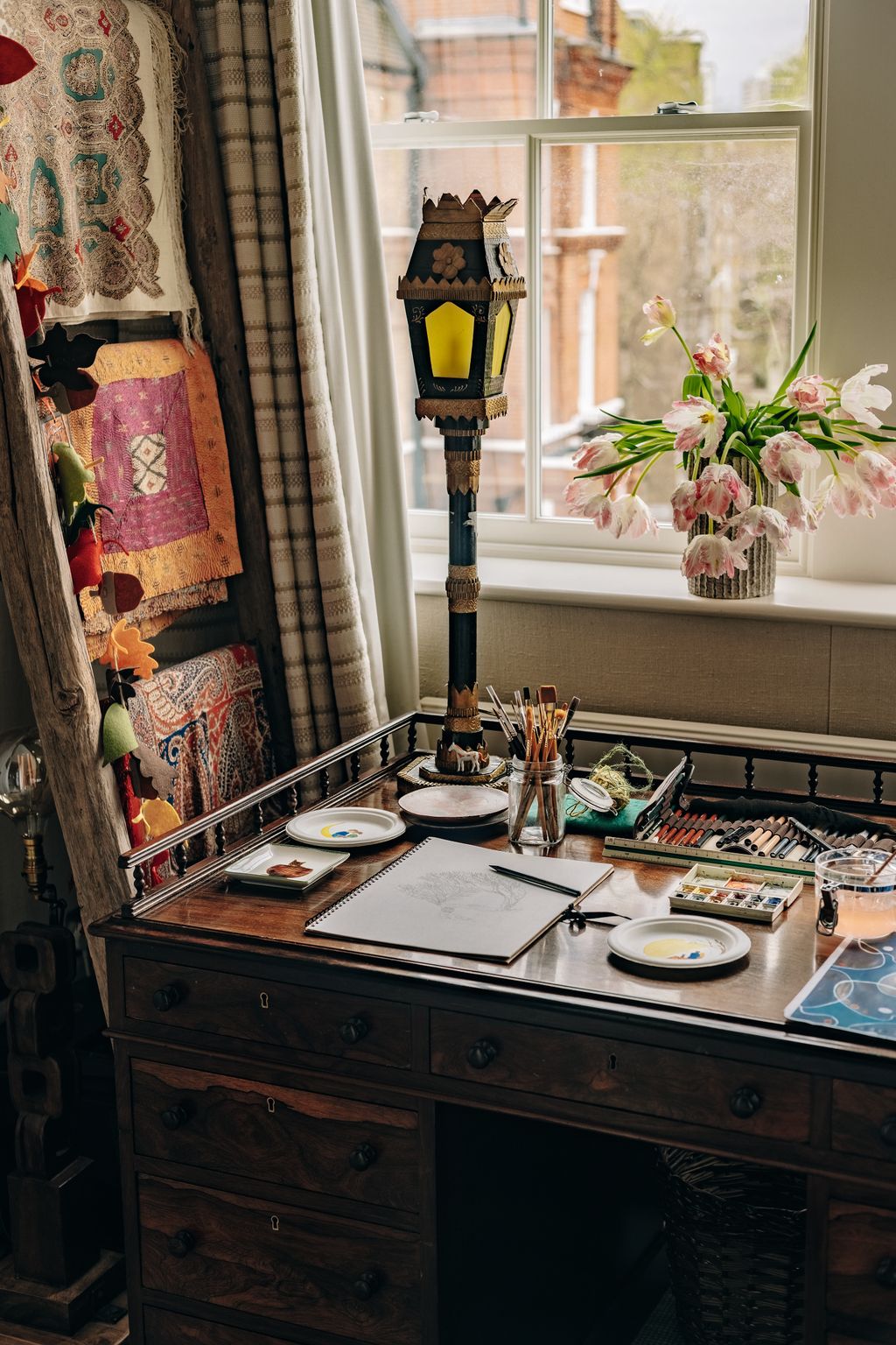 Image may contain Furniture Table Book Publication Tabletop Plate Lamp Pen Indoors Interior Design Cup and Window
