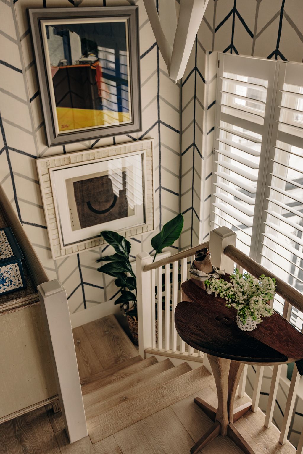 Image may contain Indoors Interior Design Art Painting Plant Architecture Building Foyer Furniture and Table