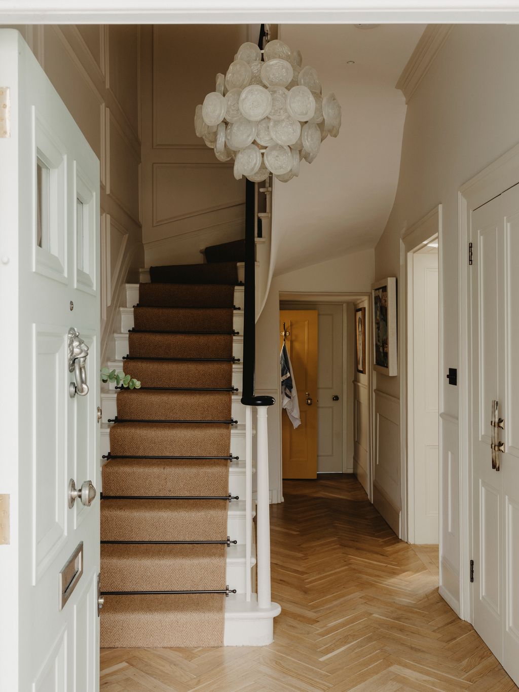 Image may contain Architecture Building Foyer Indoors Interior Design House Housing Staircase Flag and Art