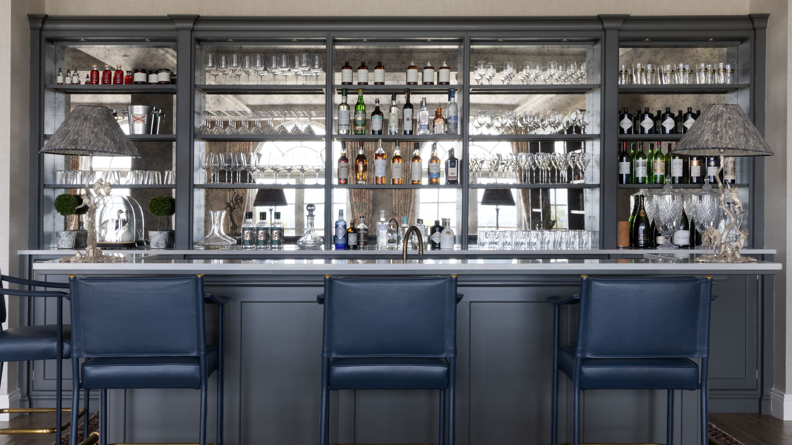 Image may contain: Alcohol, Bar, Bar Counter, Beverage, Pub, Chair, Furniture, and Plant