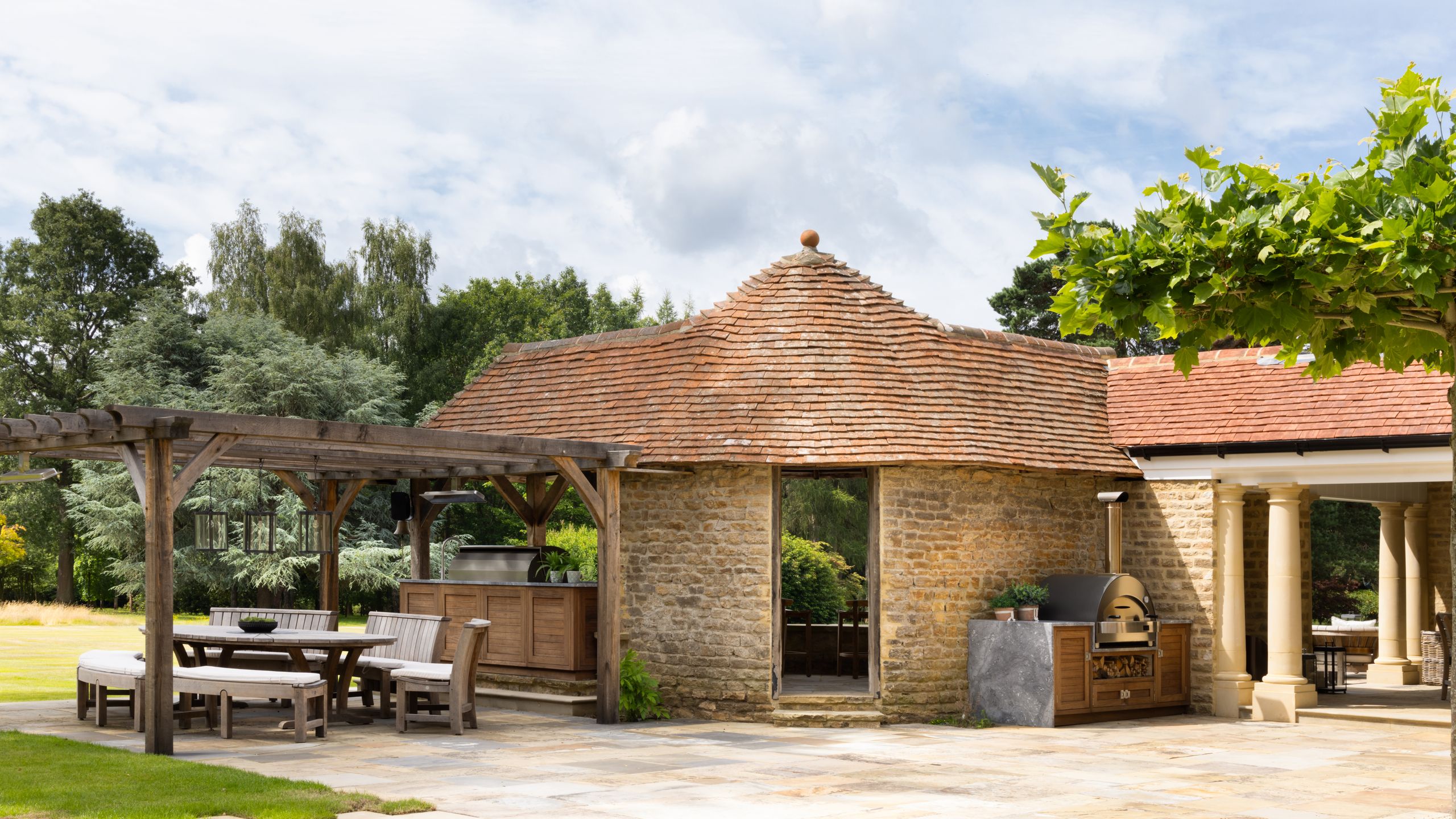 Image may contain: Architecture, Building, House, Housing, Patio, Porch, Plant, Desk, Furniture, Table, Outdoors, and Pergola