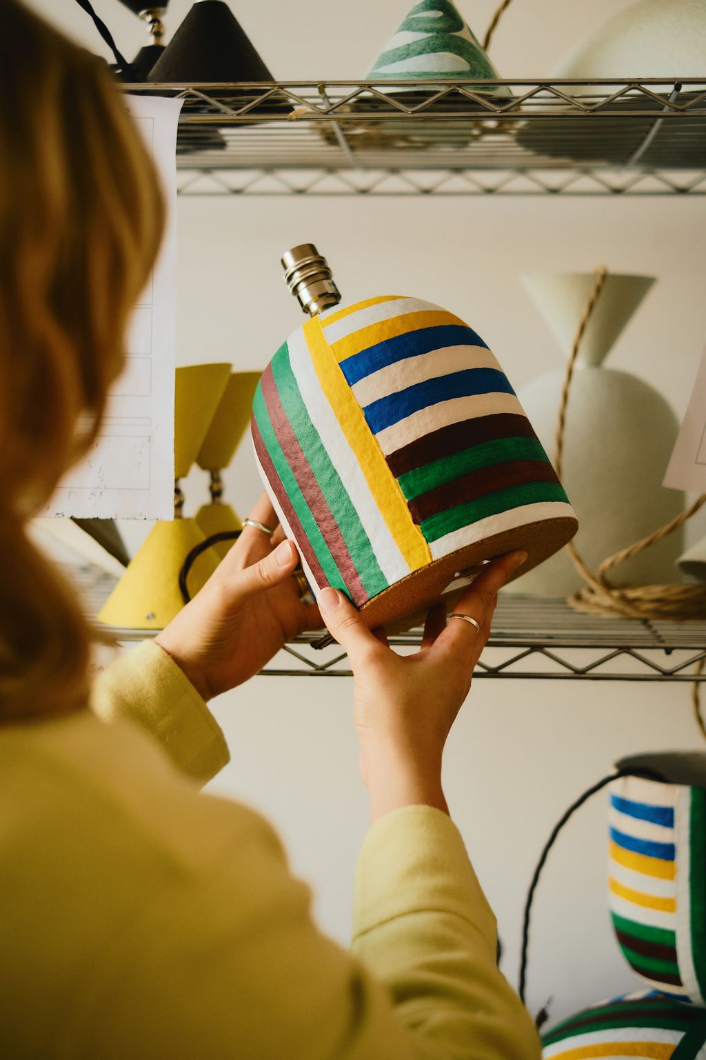 Image may contain Clothing Hat Adult Person Accessories Jewelry Ring Lamp Art and Handicraft