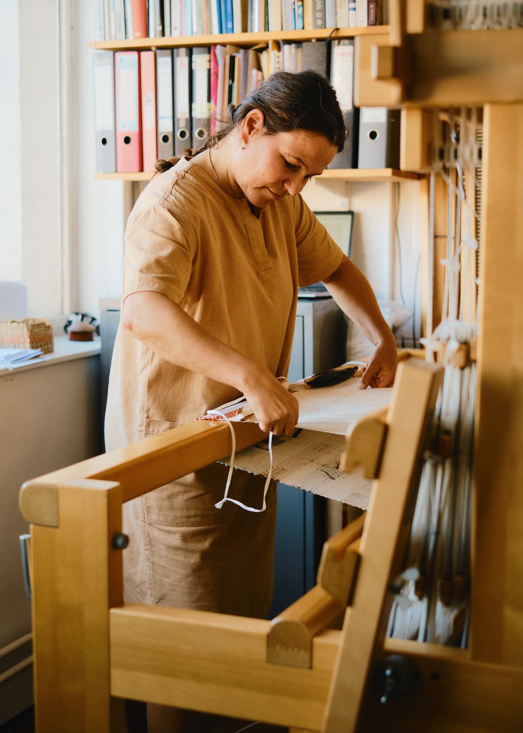 Image may contain Olivia Wigzell Adult Person Weaving Computer Electronics Laptop and Pc