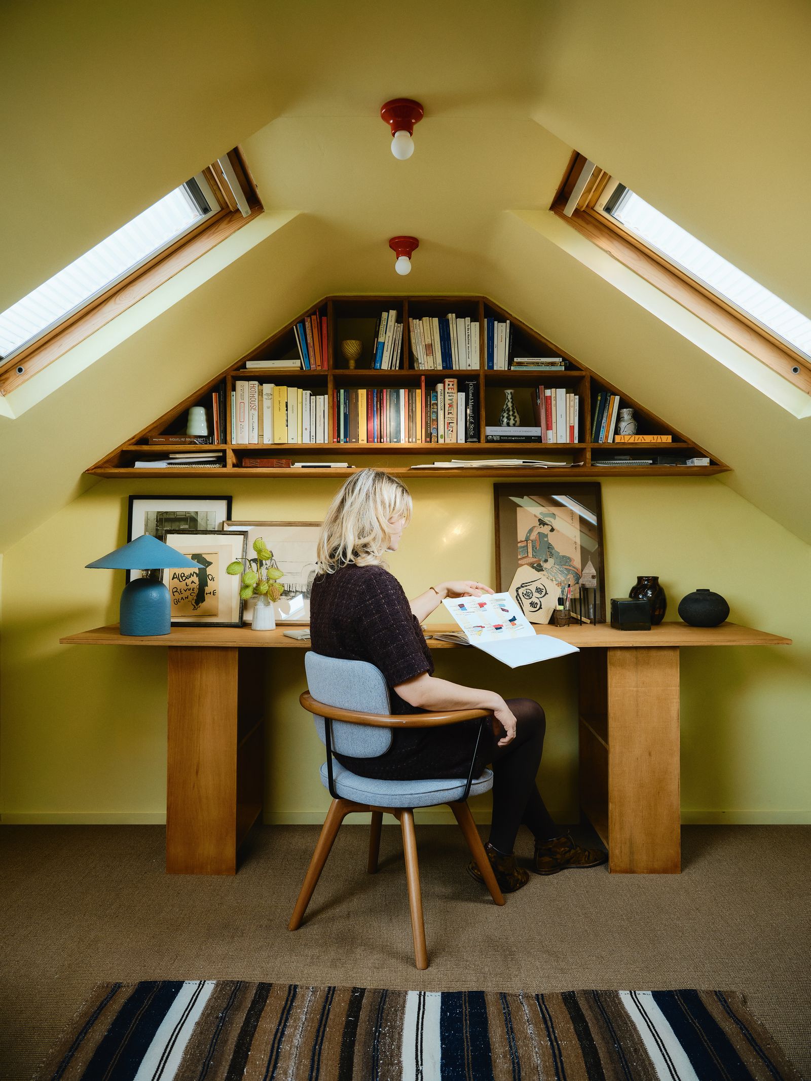 Image may contain Furniture Table Chair Adult Person Clothing Footwear Shoe Lamp Desk Architecture and Building