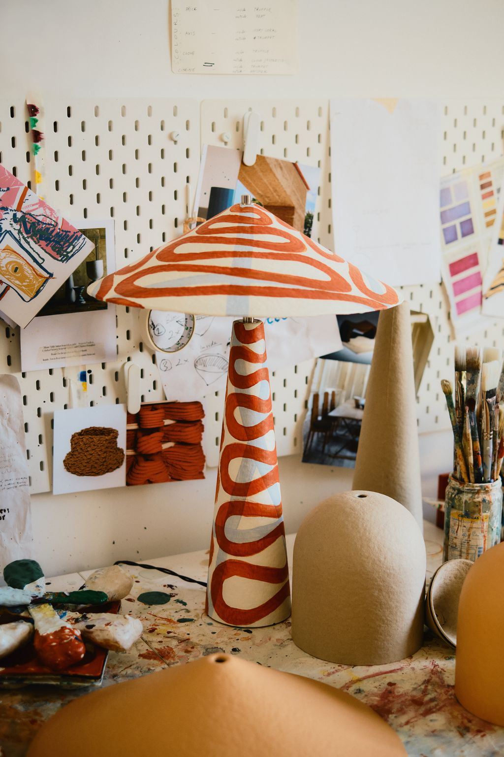 Image may contain Clothing Hat Baby Person Furniture Table Lamp Bread and Food