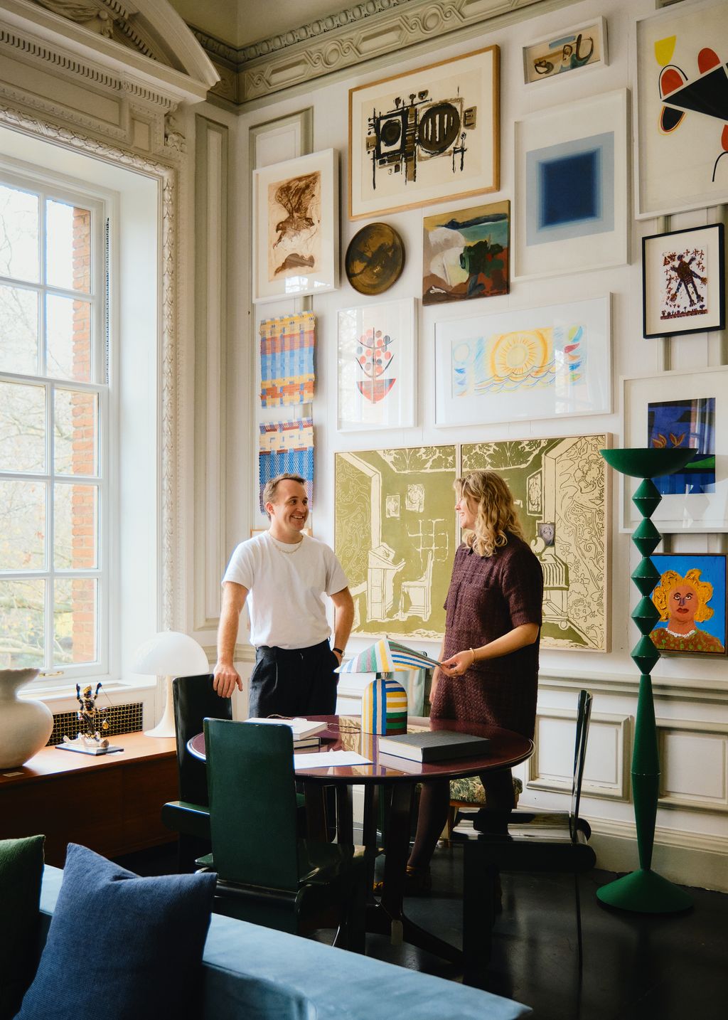 Image may contain Kim McGuire Furniture Table Adult Person Desk Lamp Architecture Building and Dining Room