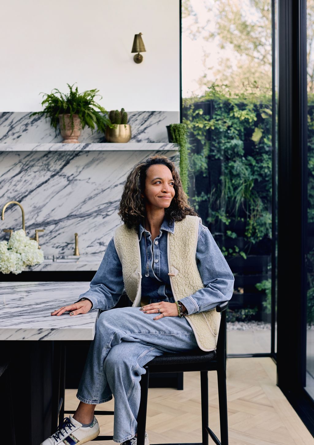 Image may contain Person Sitting Plant Lamp Clothing Footwear Shoe Adult Accessories Jewelry Ring and Chair