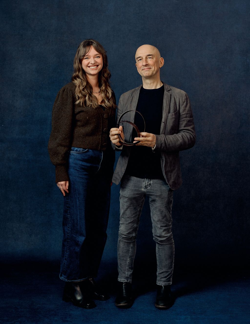 Image may contain Clothing Pants Coat Jacket Blazer Jeans Adult Person Face Happy Head Smile Footwear and Shoe