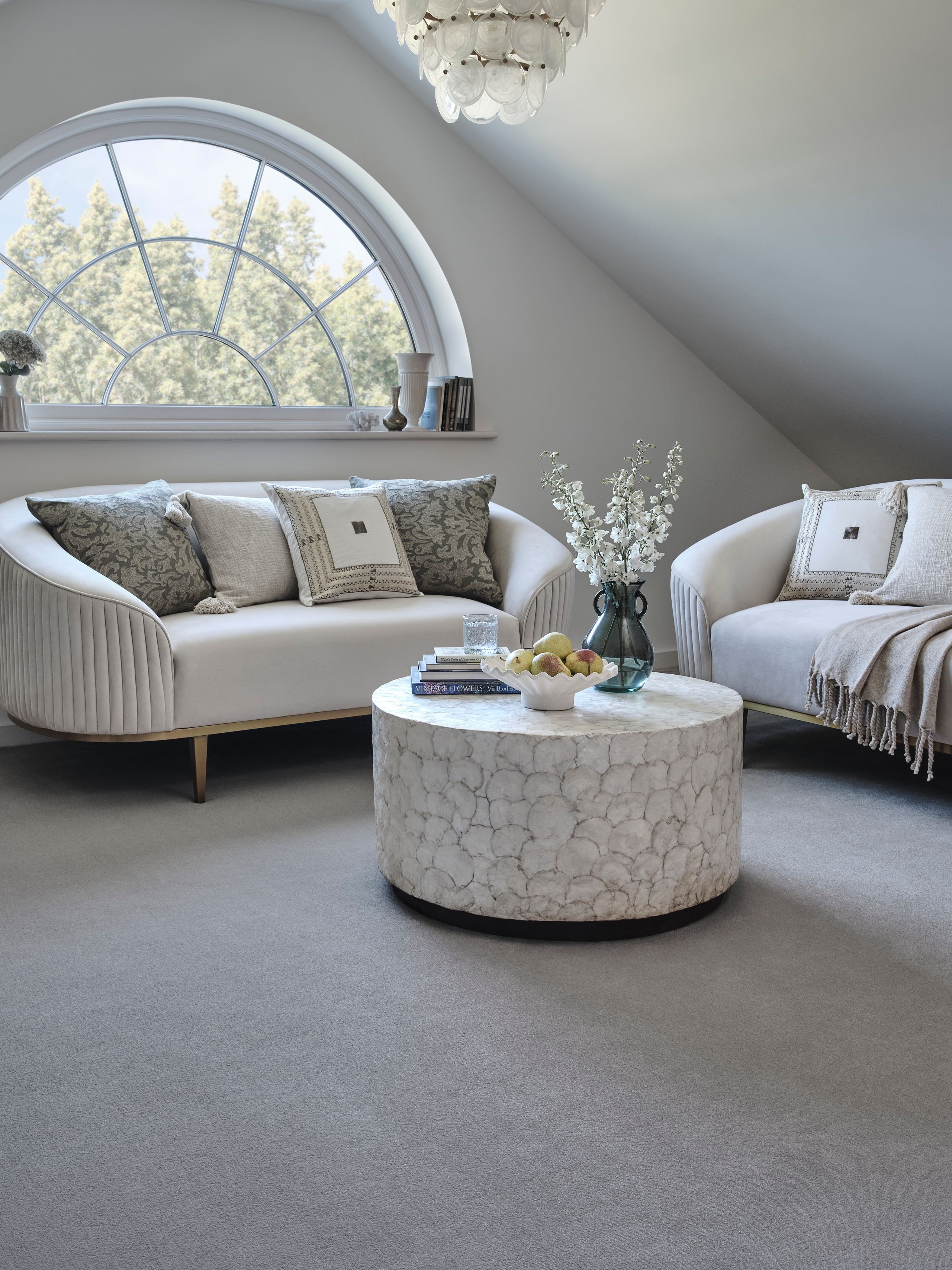 Image may contain: Furniture, Couch, Lamp, Cup, Home Decor, Plant, and Table