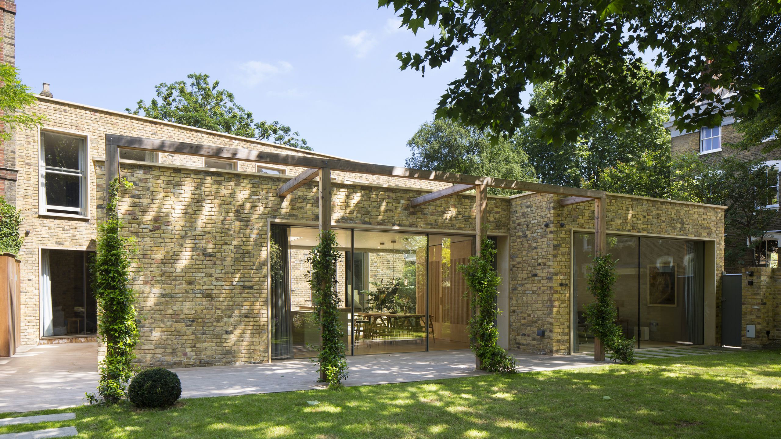 Image may contain: Architecture, Building, House, Housing, Porch, Patio, Pergola, Grass, Plant, Backyard, and Nature