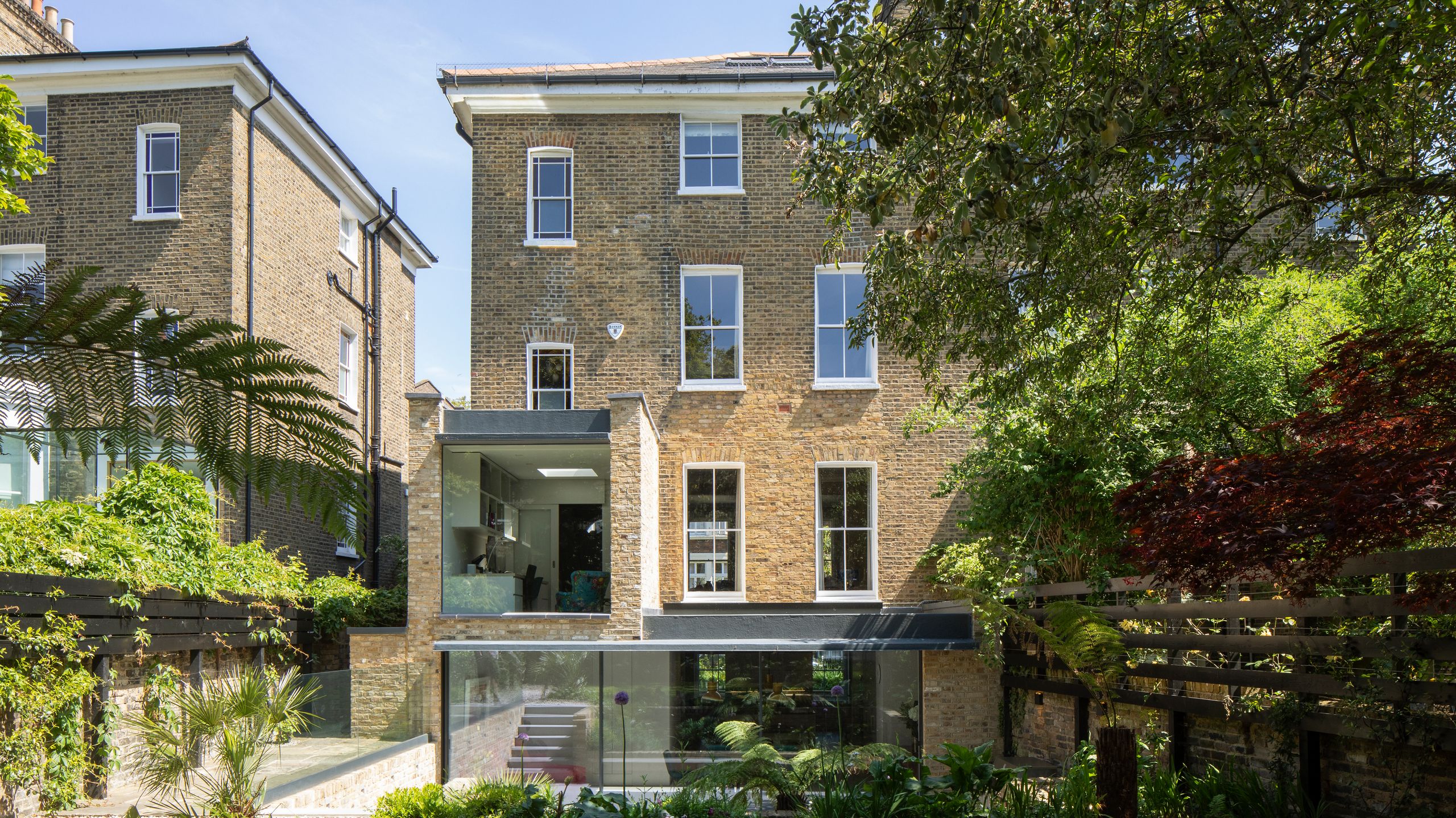 Image may contain: Grass, Plant, City, Architecture, Building, Condo, Housing, Urban, House, Villa, High Rise, and Chair