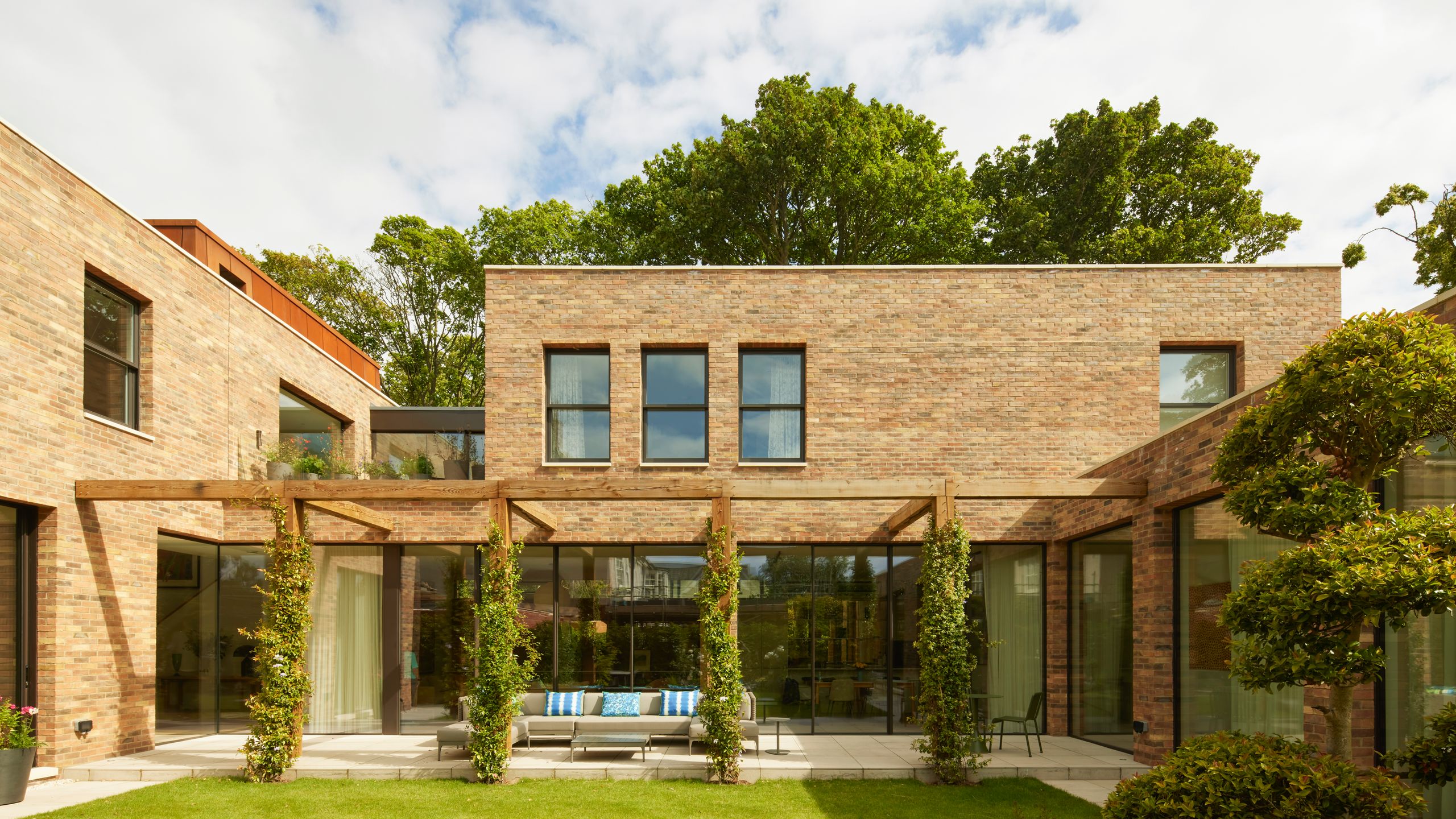 Image may contain: Grass, Plant, Chair, Furniture, Architecture, Building, House, Housing, Villa, Lawn, Door, and Porch