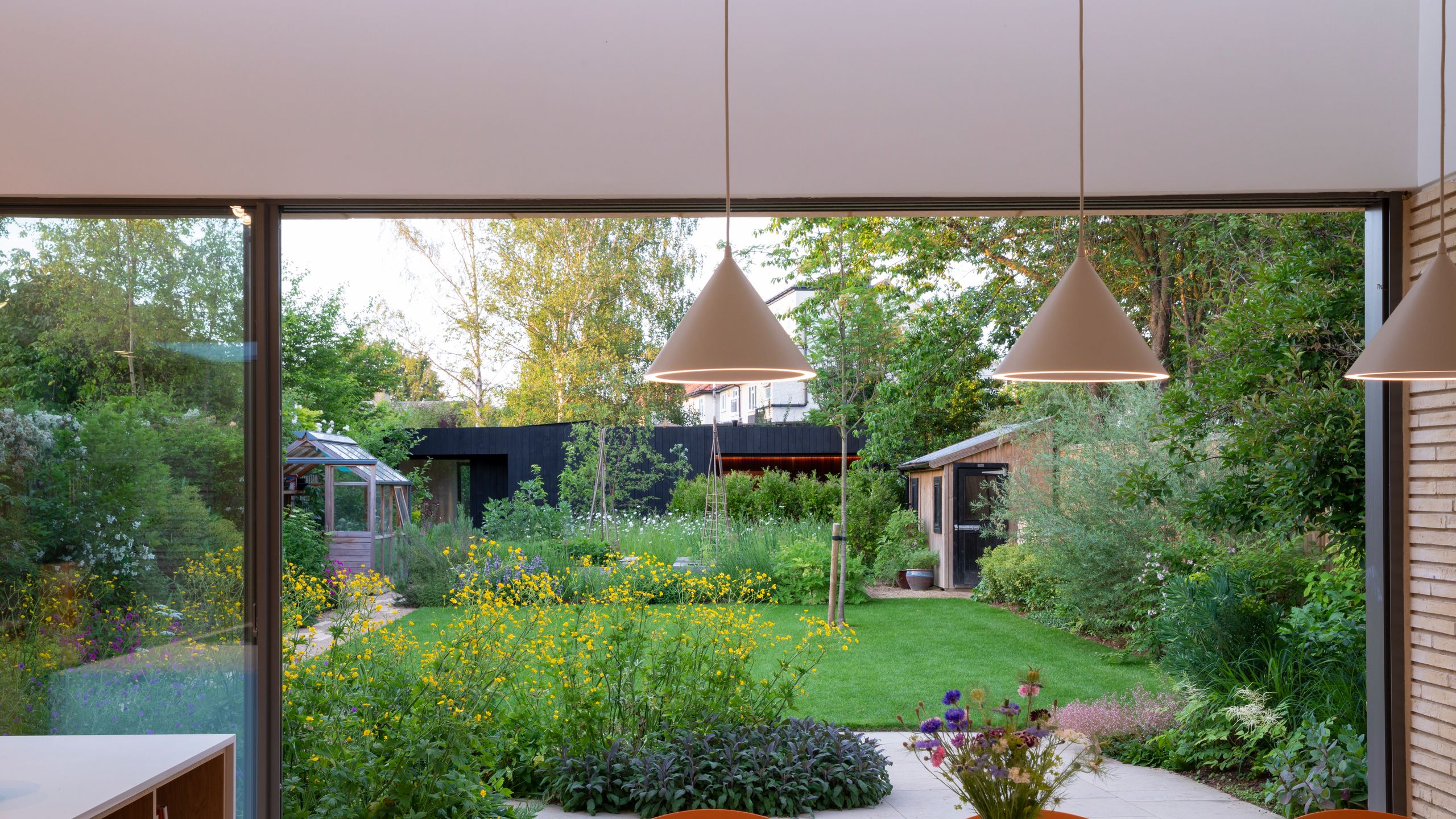 Image may contain: Indoors, Interior Design, Backyard, Nature, Outdoors, Yard, Lamp, Grass, Plant, Chair, and Furniture