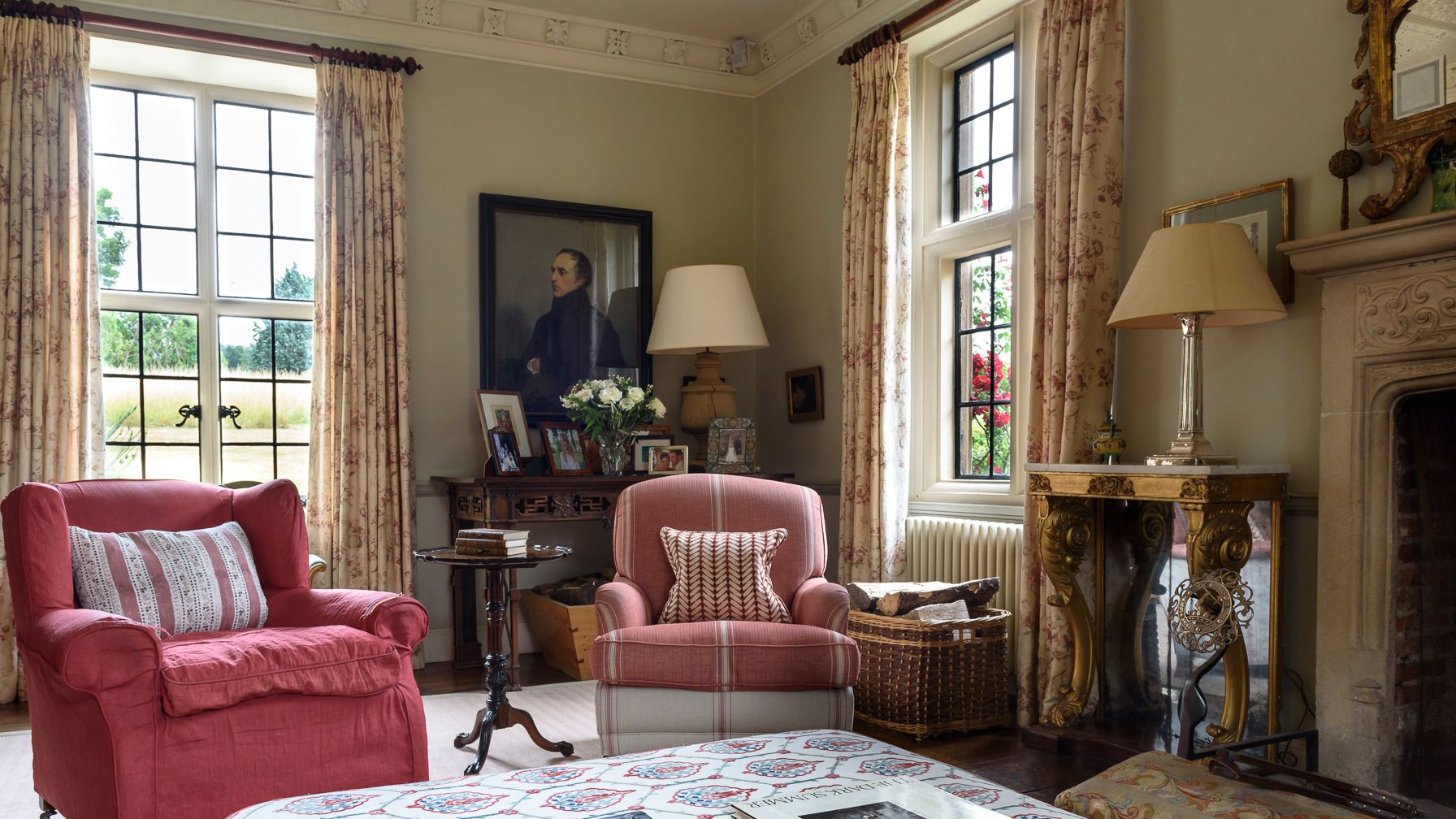 Image may contain: Lamp, Book, Publication, Home Decor, Art, Painting, Desk, Furniture, Table, Person, and Couch