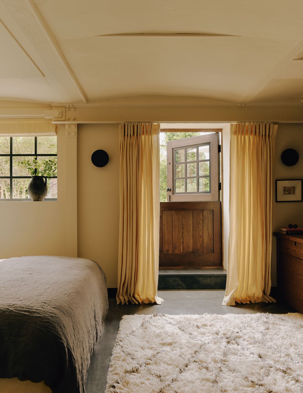 Image may contain Indoors Interior Design Home Decor Rug Art Painting Bed Furniture Door Plant and Architecture