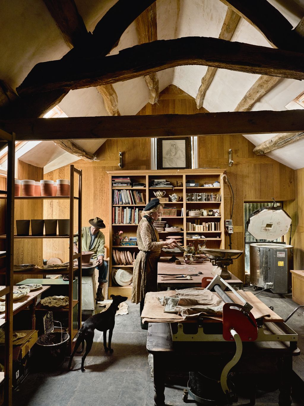 Image may contain Architecture Building Factory Adult Person Clothing Hat Manufacturing Wood Art and Painting