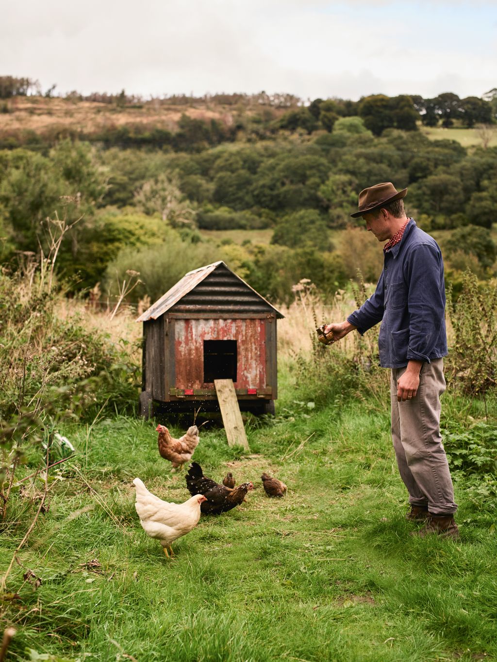 Image may contain Clothing Hat Animal Bird Chicken Fowl Poultry Architecture Building Outdoors Shelter and Adult