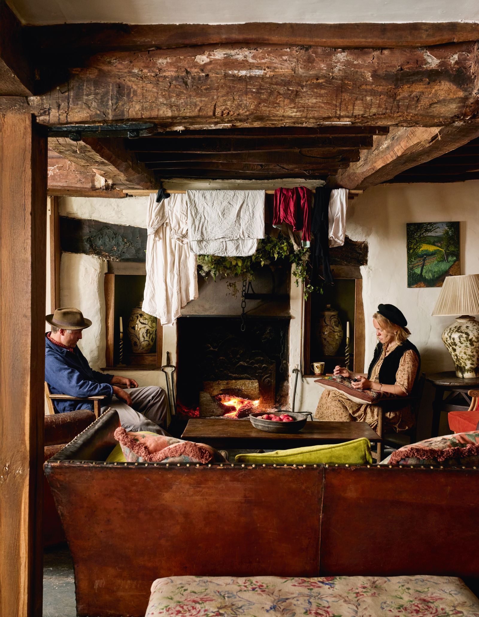 Image may contain Lamp Clothing Hat Furniture Adult Person Bed Bedroom Indoors Room Cup Book and Publication