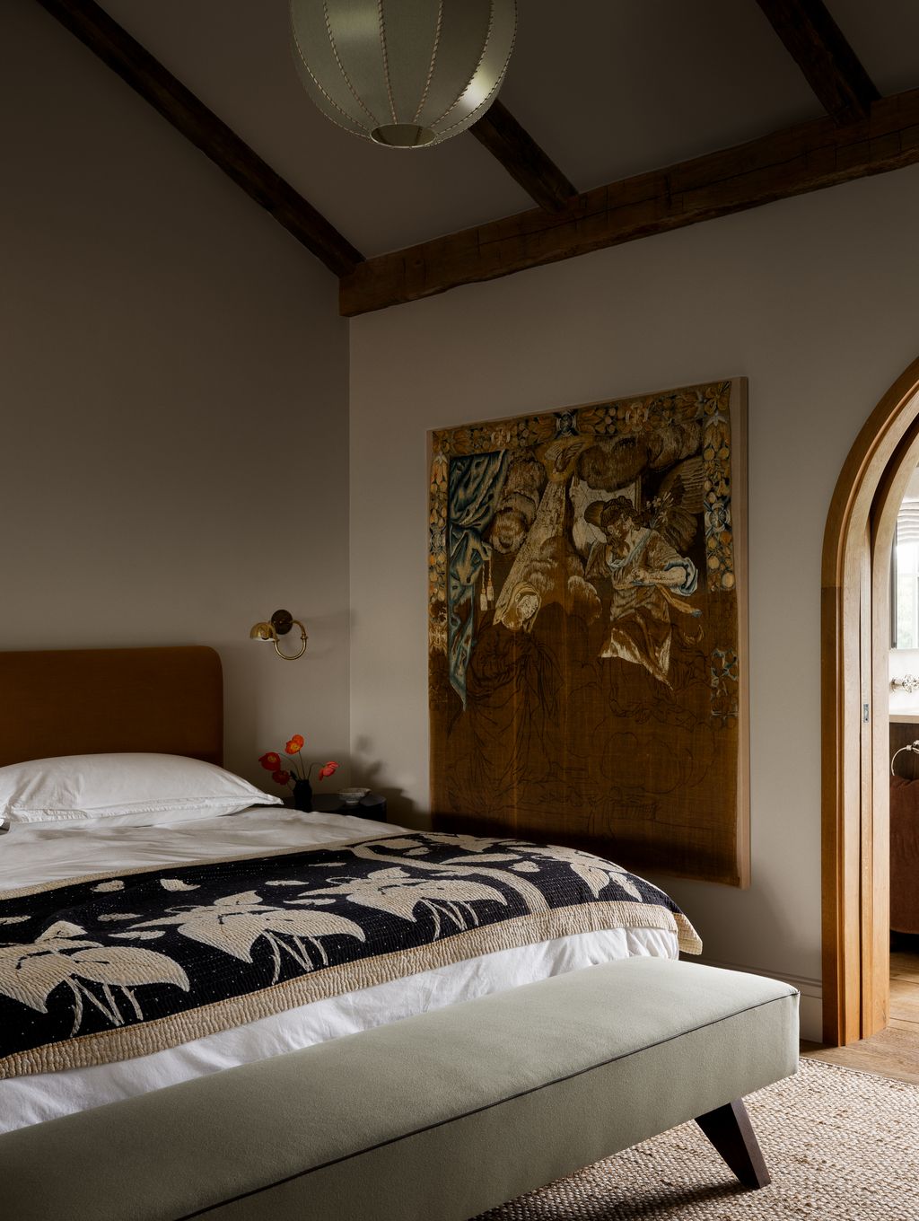 Image may contain Indoors Interior Design Bed Furniture Home Decor Lamp Person Bedroom Room Bench and Wood Panels