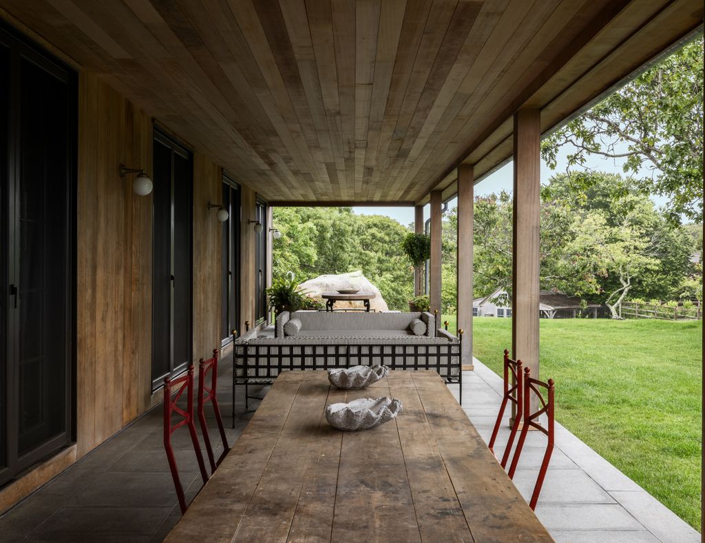 Image may contain Indoors Interior Design Architecture Building House Housing Porch Desk Furniture Table and Lamp