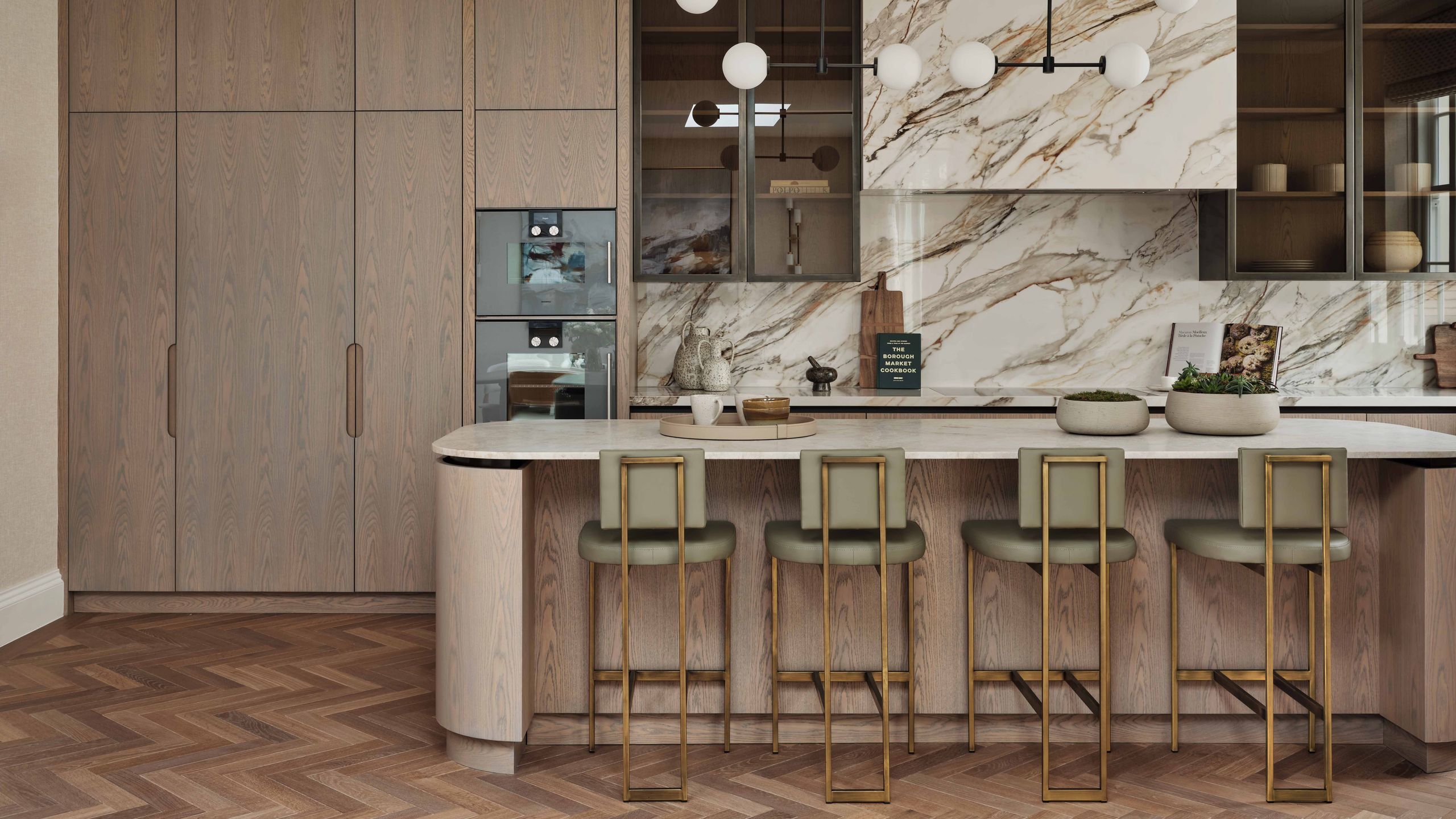 Image may contain: Indoors, Interior Design, Chair, Furniture, Kitchen, Plant, Wood Panels, Floor, Cup, Desk, and Table