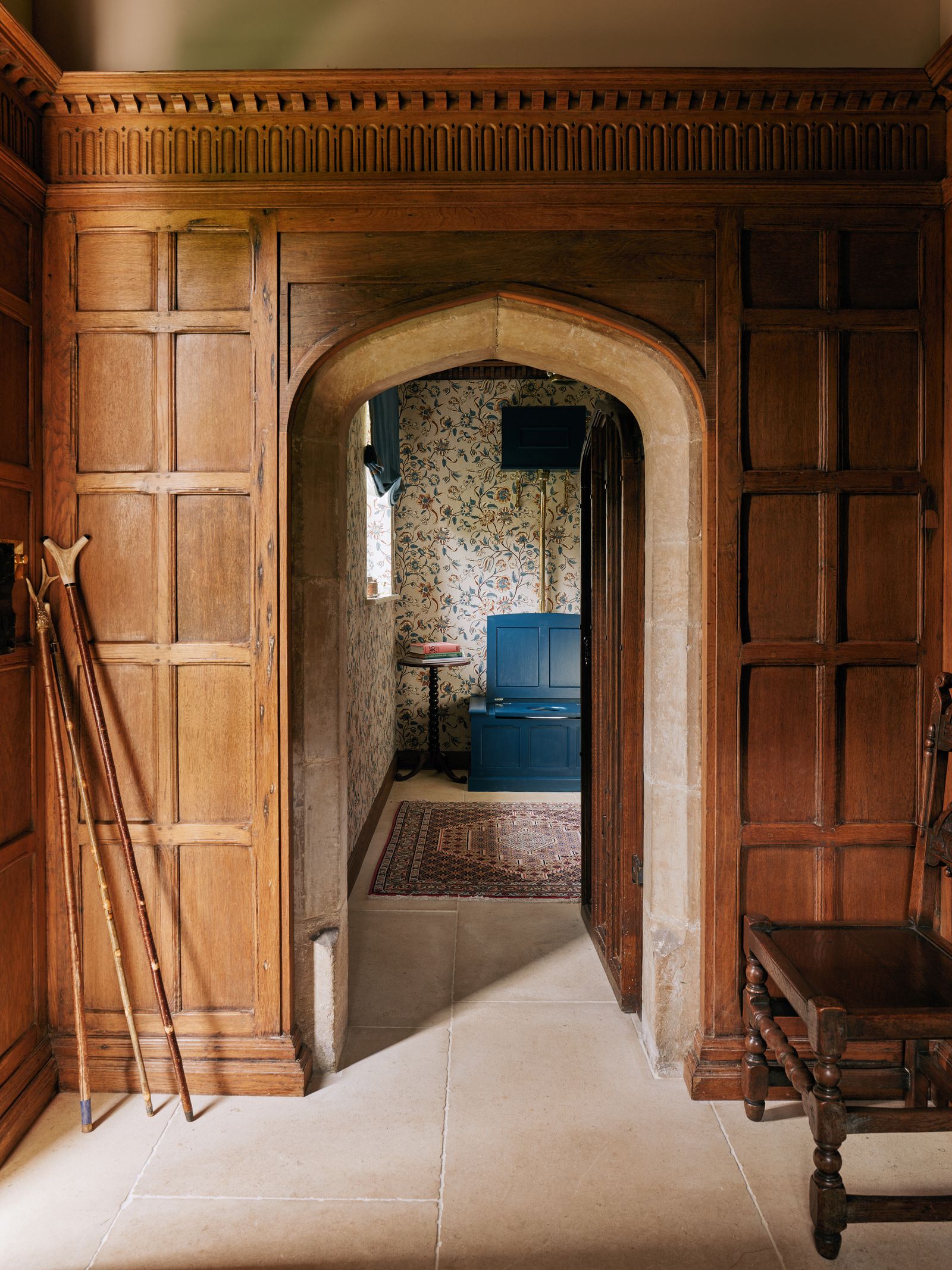 Image may contain Indoors Interior Design Floor Flooring Wood Home Decor Rug Desk Furniture Table and Arch