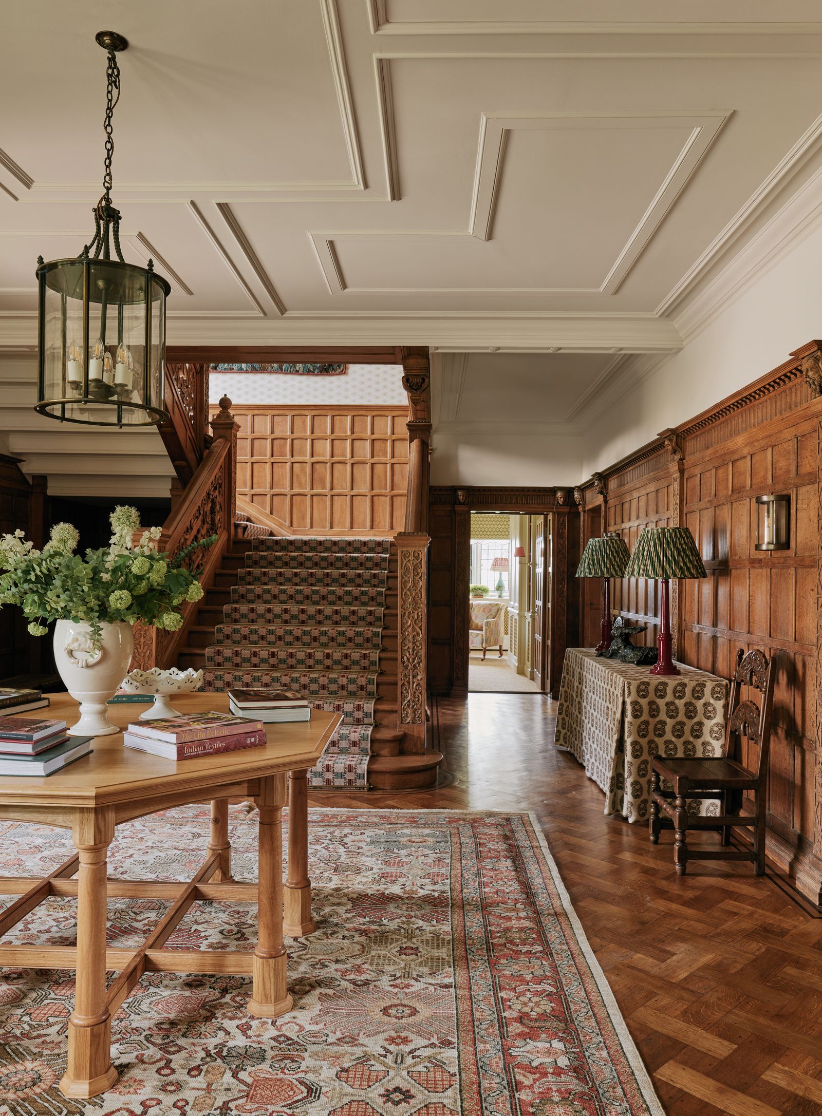 Image may contain Indoors Interior Design Architecture Building Foyer Lamp Chair Furniture Book and Publication