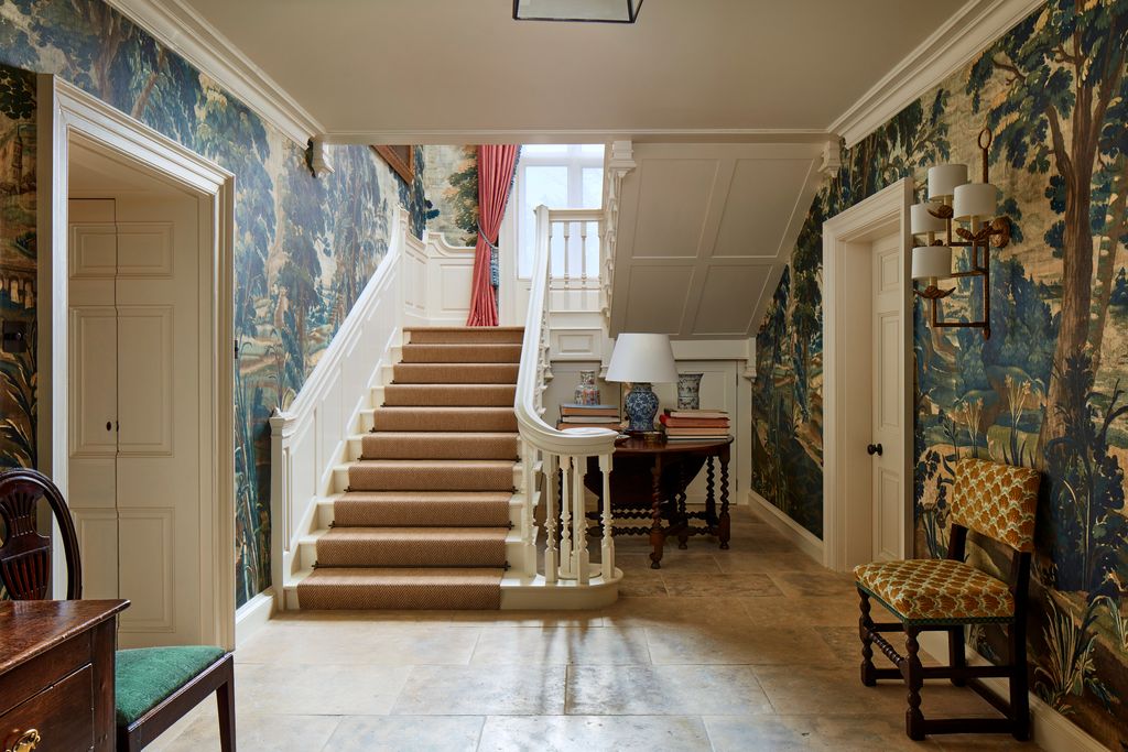 Image may contain Lamp Indoors Architecture Building Foyer Chair Furniture House Housing Staircase Desk and Table
