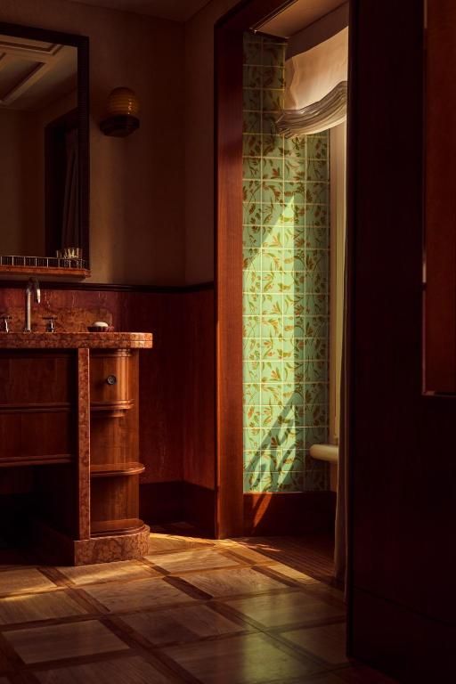 Image may contain Indoors Interior Design Floor Flooring Wood Sink Sink Faucet Hardwood and Furniture
