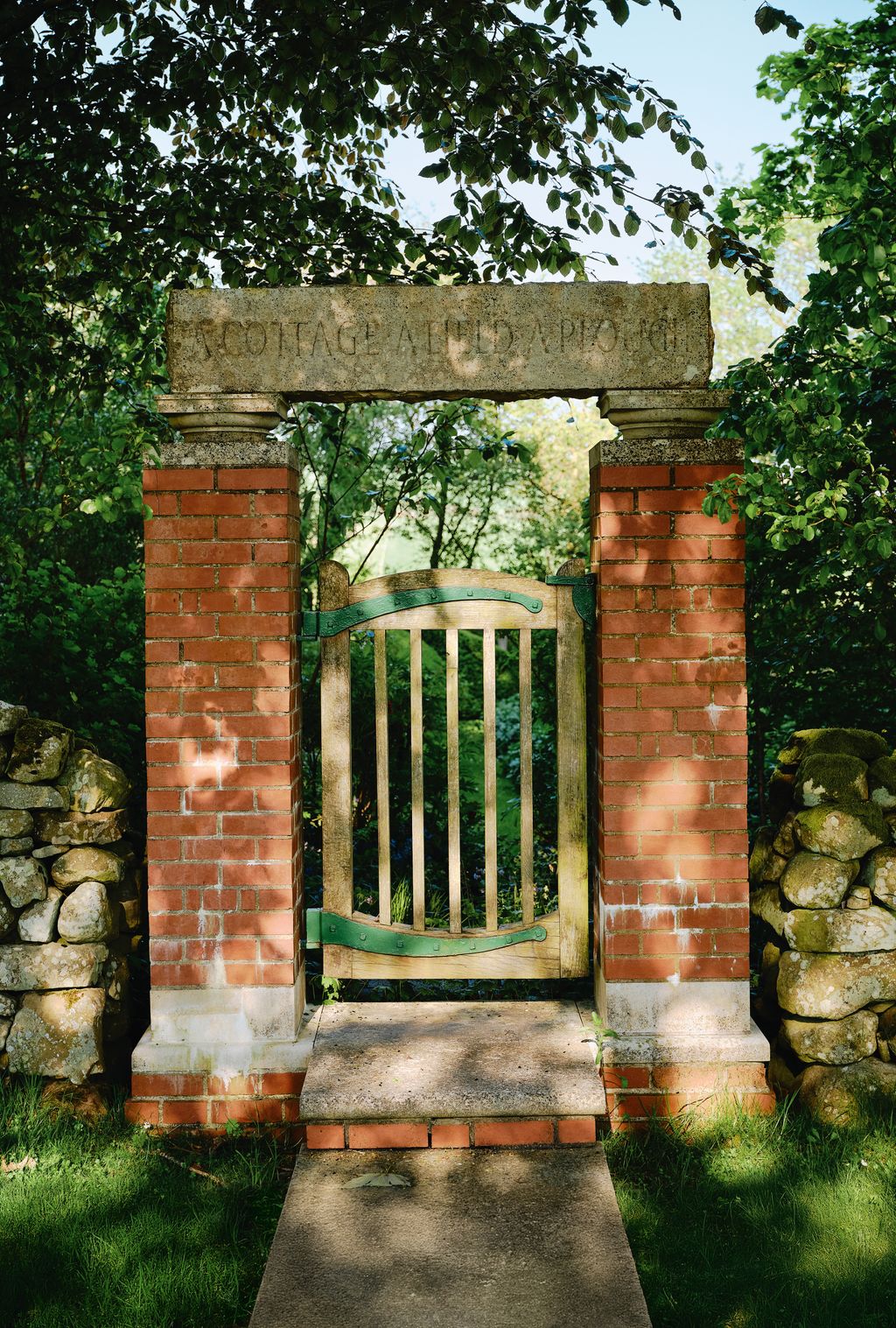 Image may contain Gate Outdoors Brick Nature Grass and Plant