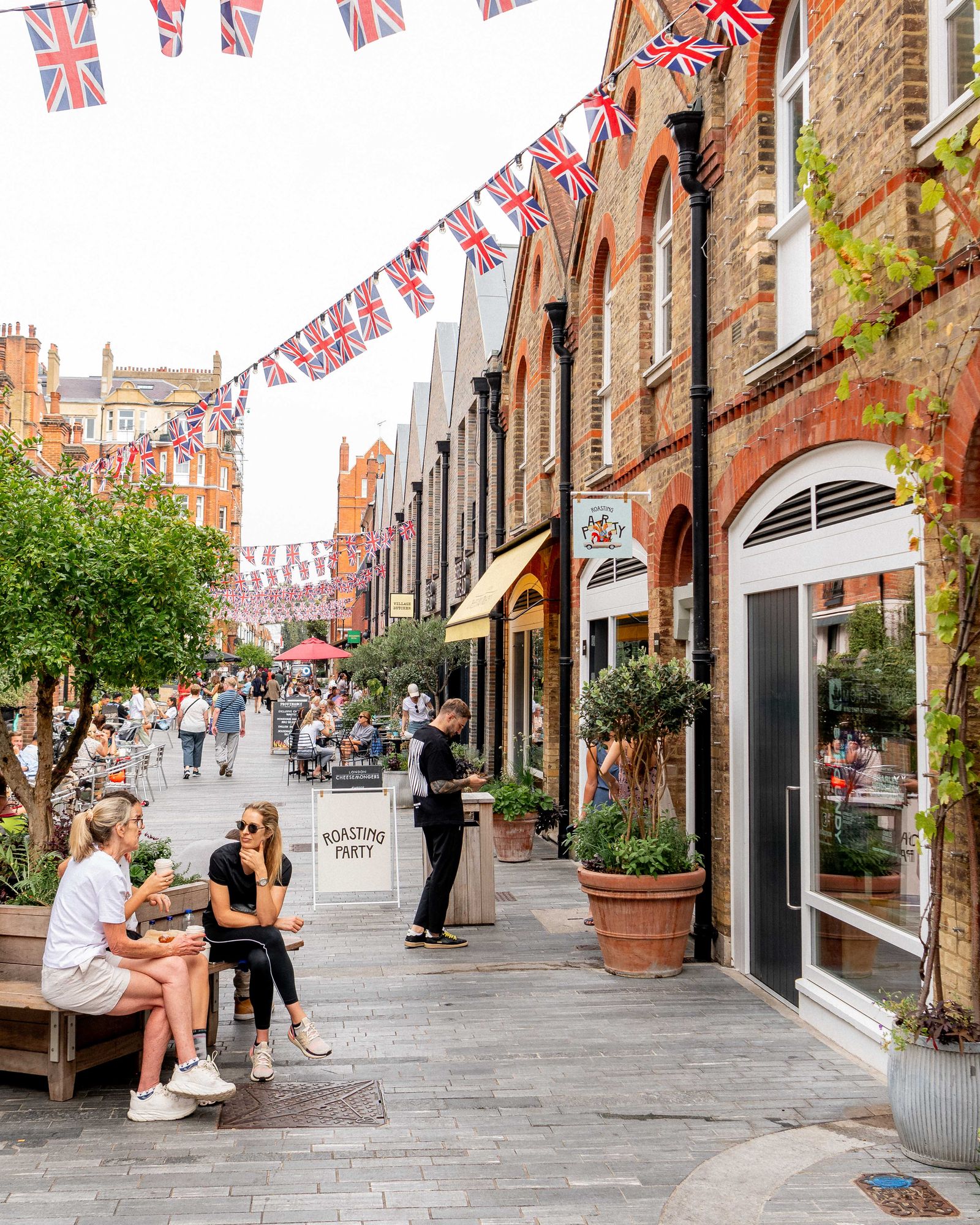 Image may contain City Urban Road Street People Person Plant Downtown Clothing Footwear Shoe Adult and Flag