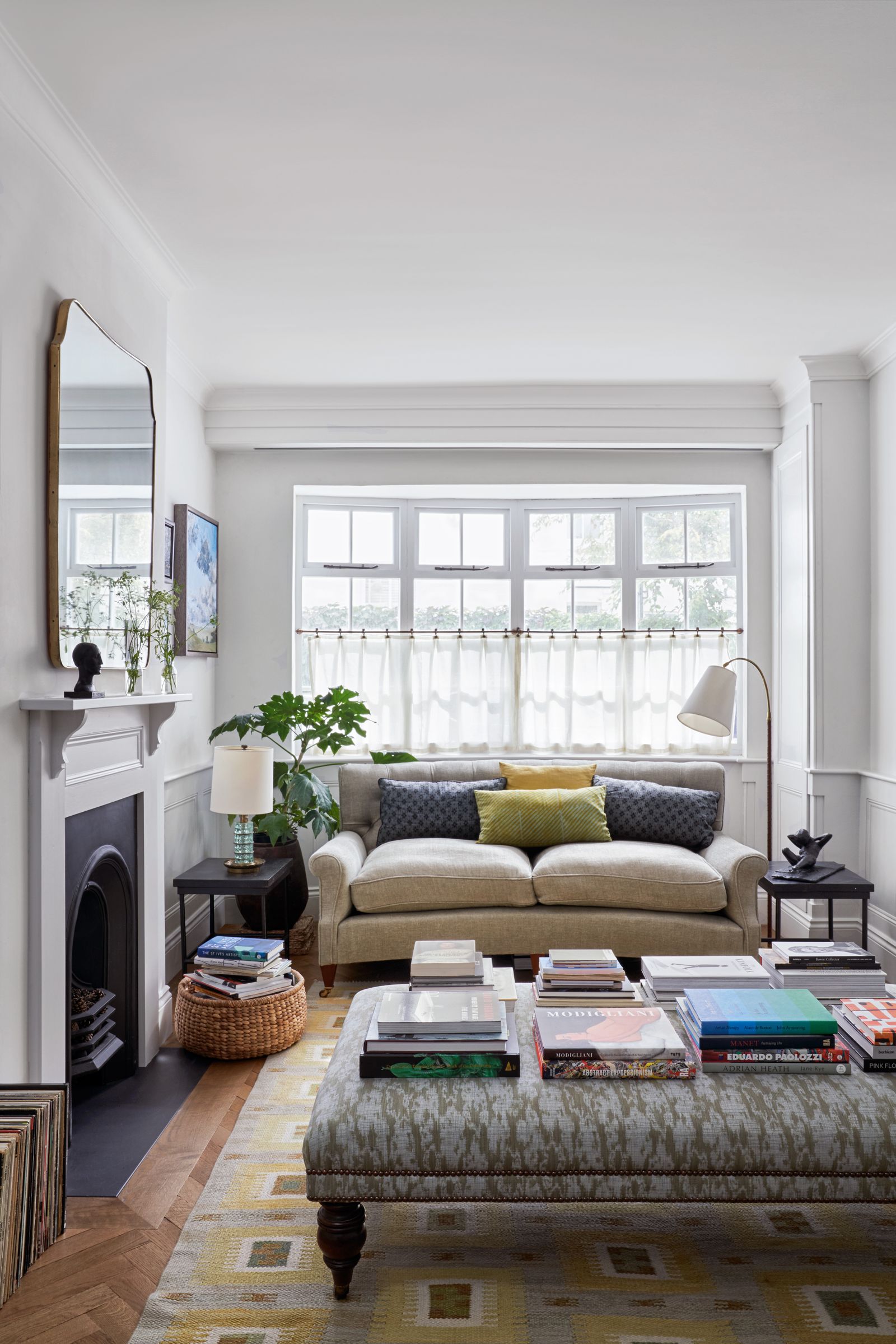 Image may contain Home Decor Couch Furniture Rug Window Plant Architecture Building Indoors Living Room and Room