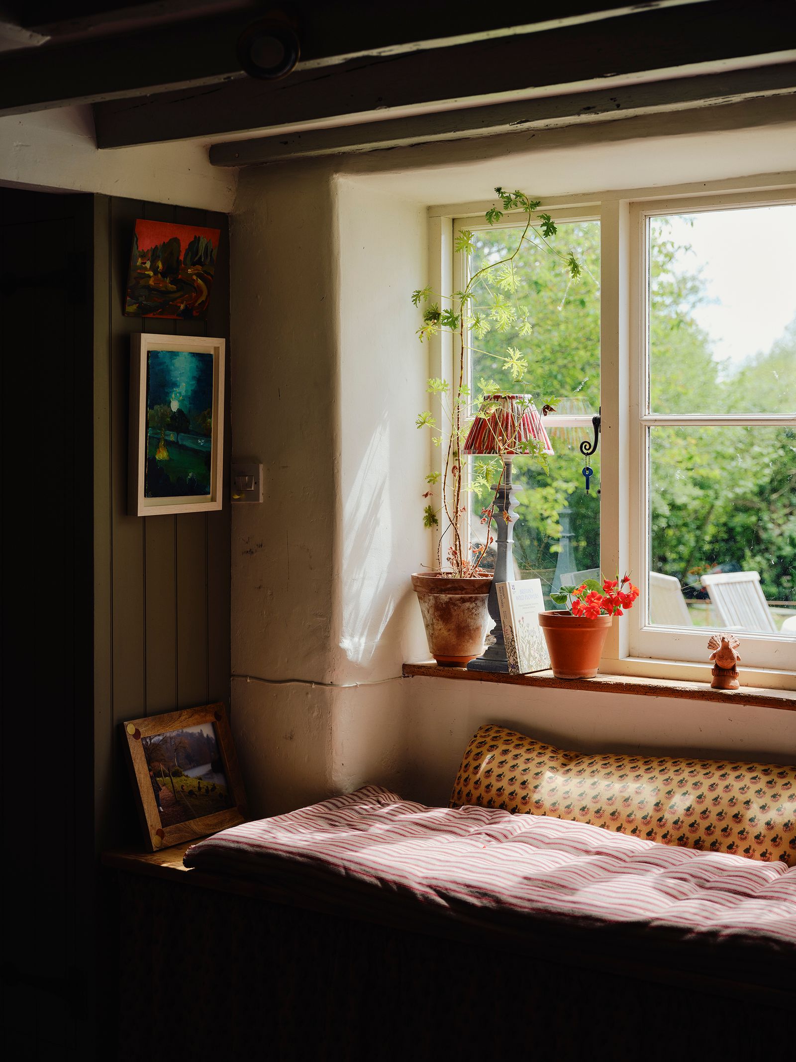 Image may contain Window Plant Lamp Art Painting Bed Furniture Windowsill Chair and Bay Window