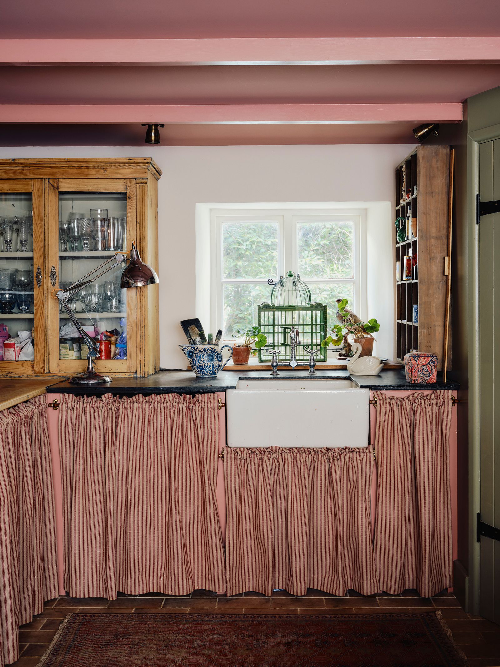 Image may contain Indoors Interior Design Home Decor Rug Plant Sink Window Kitchen and Lamp