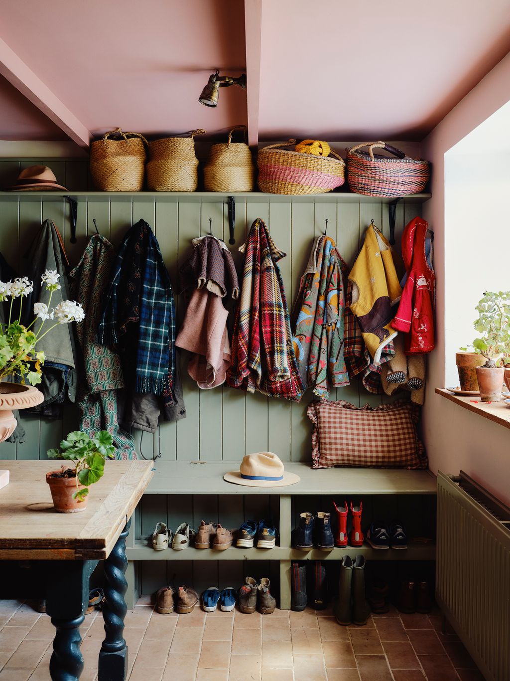 Image may contain Indoors Interior Design Lamp Plant Clothing Hat Desk Furniture Table Accessories and Bag