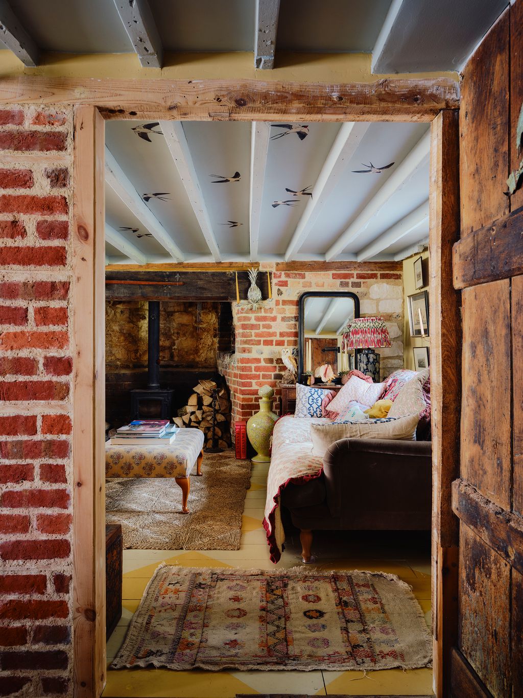 Image may contain Indoors Interior Design Home Decor Couch Furniture Lamp Rug Art Painting Bed Bedroom and Room