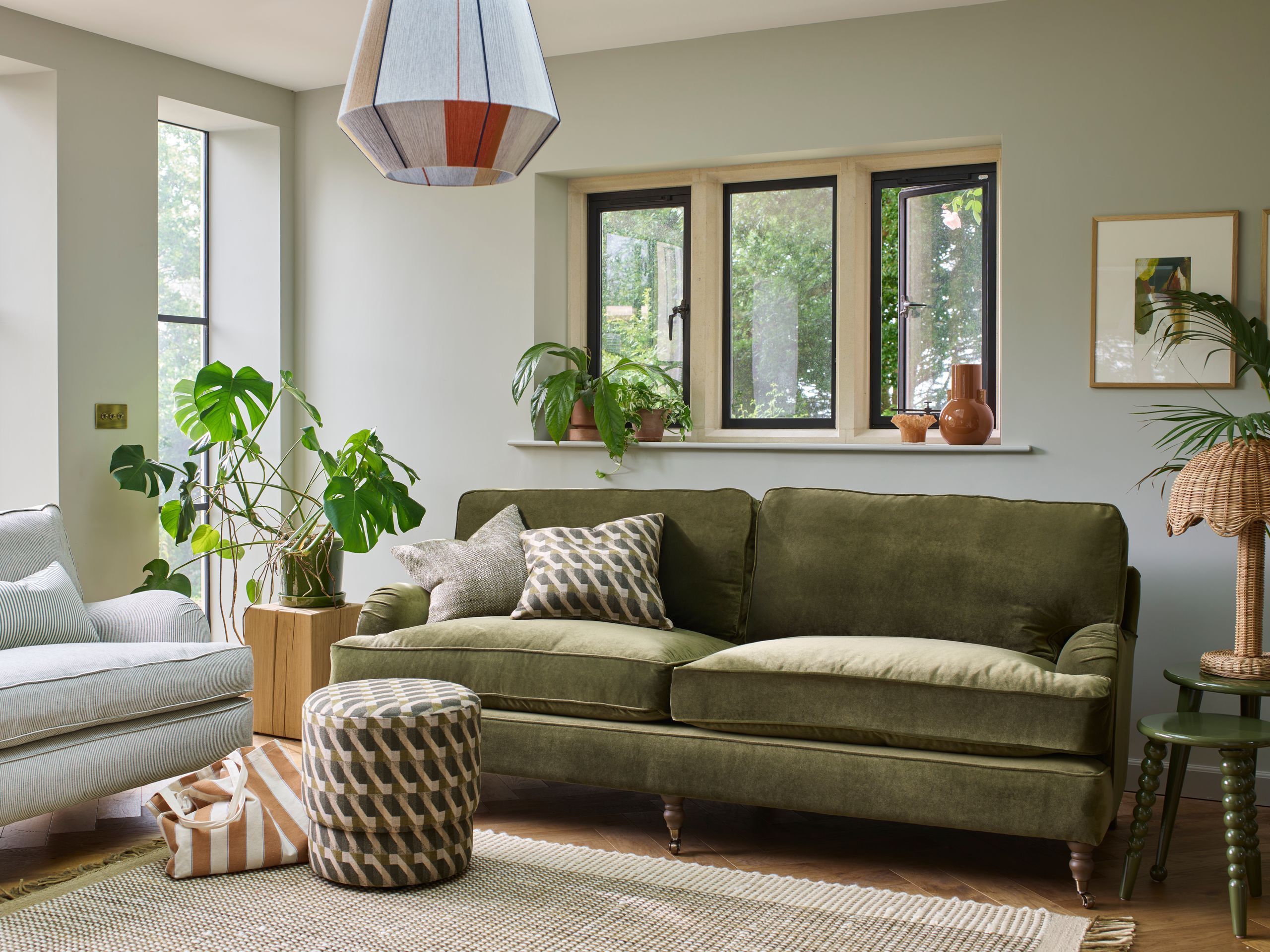 Image may contain: Home Decor, Lamp, Couch, Furniture, Architecture, Building, Indoors, Living Room, Room, Plant, and Rug