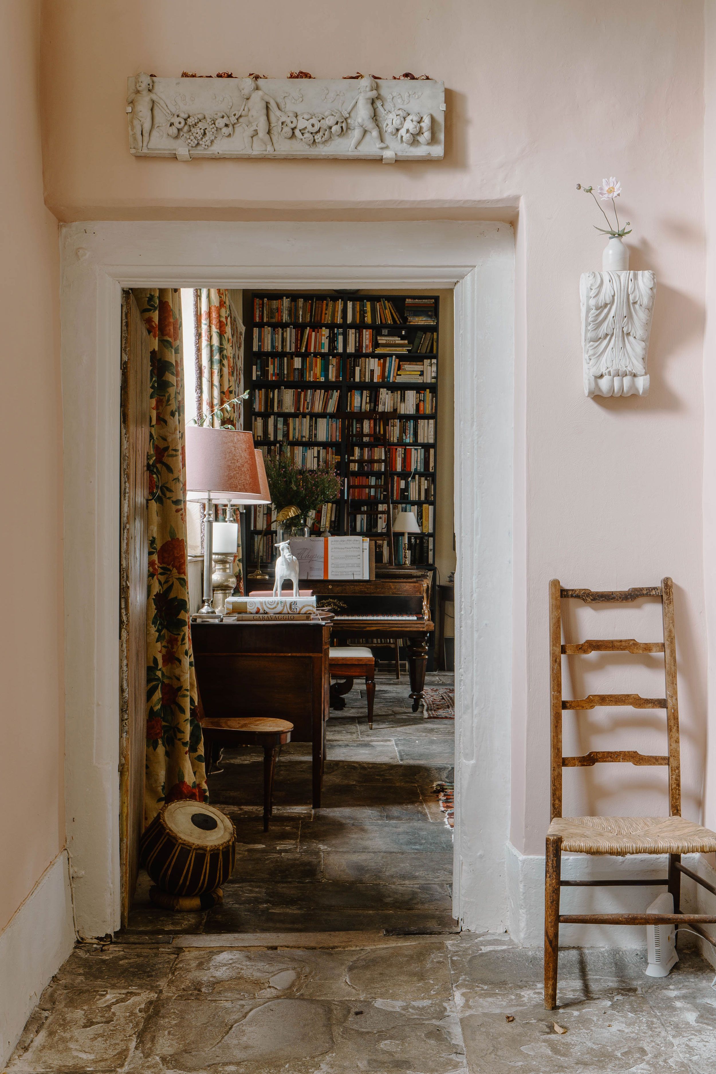 Image may contain: Floor, Chair, Furniture, Lamp, Indoors, Interior Design, Bench, Person, Flooring, and Keyboard