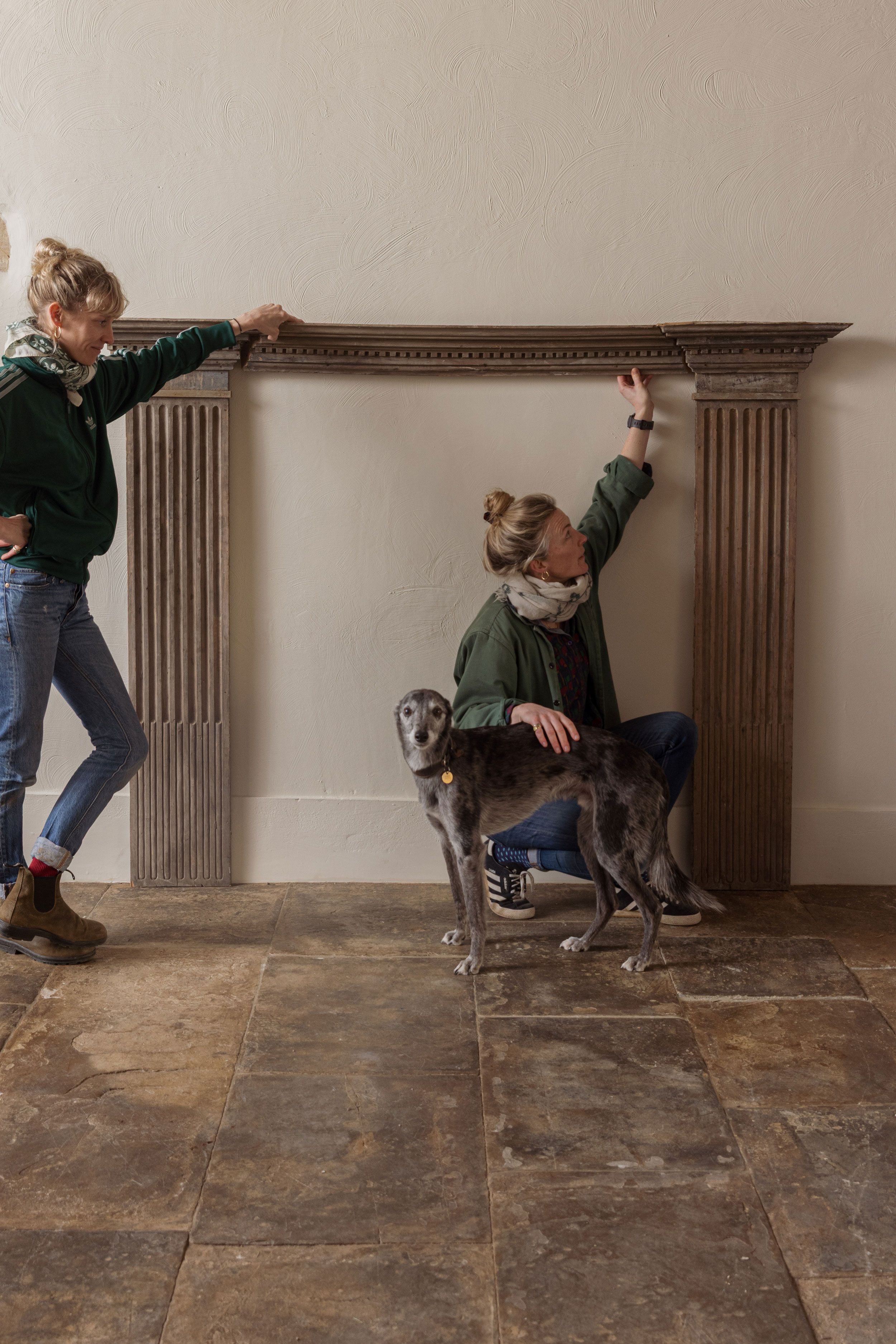 Image may contain: Clothing, Pants, Floor, Flooring, Jeans, Face, Head, Person, Photography, Portrait, Adult, and Animal