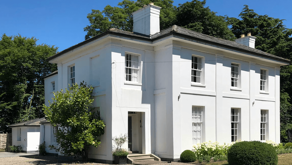 Image may contain Architecture Building Housing House Portico and Manor