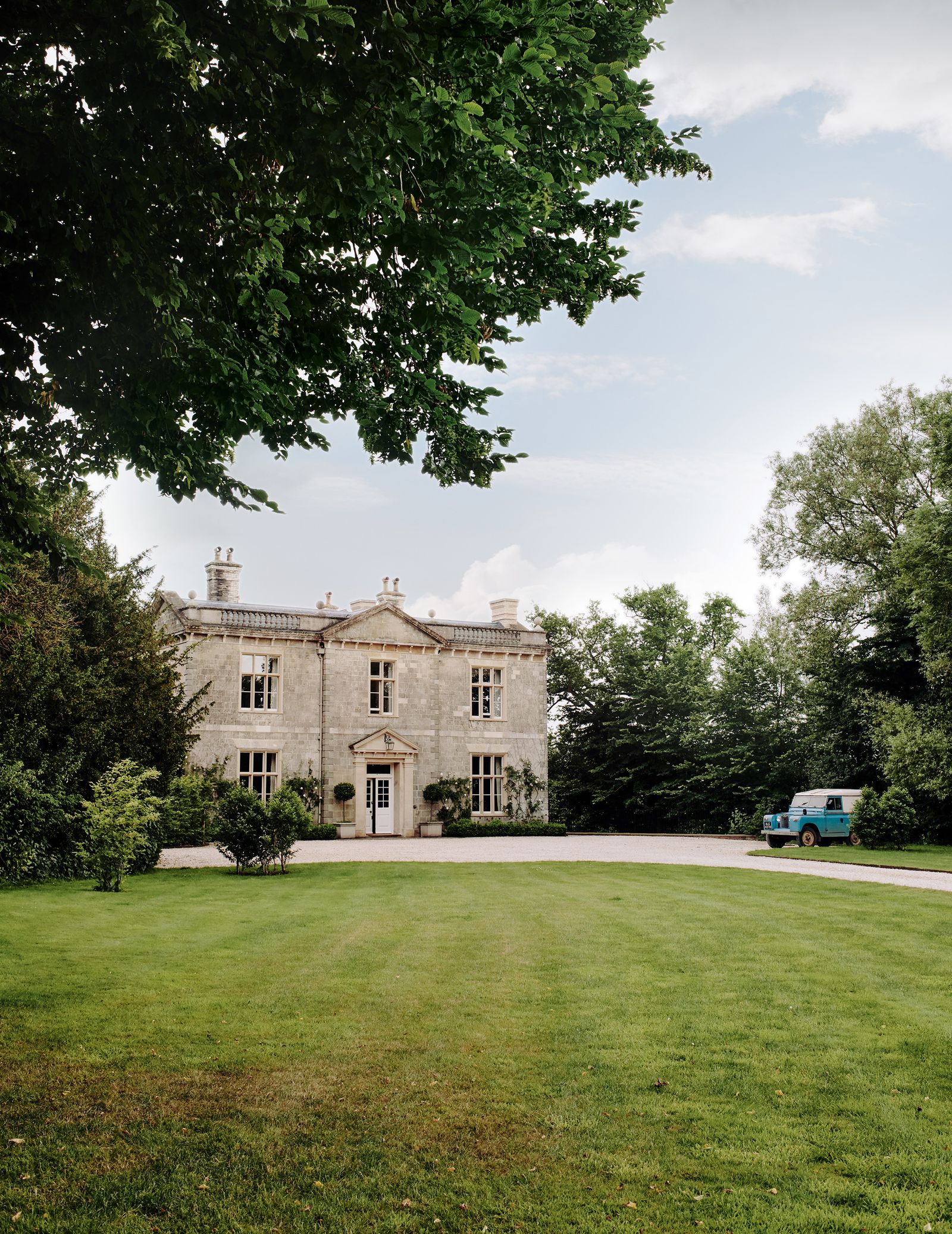 Image may contain Architecture Building Housing Grass Plant House Manor Car Transportation Vehicle and Person