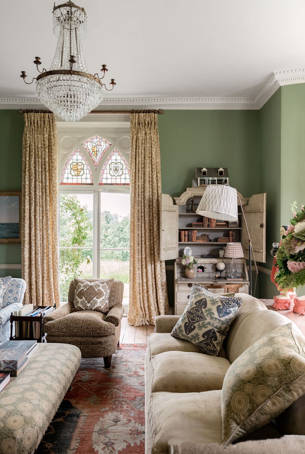 Image may contain Home Decor Couch Furniture Lamp Architecture Building Indoors Living Room Room and Chandelier