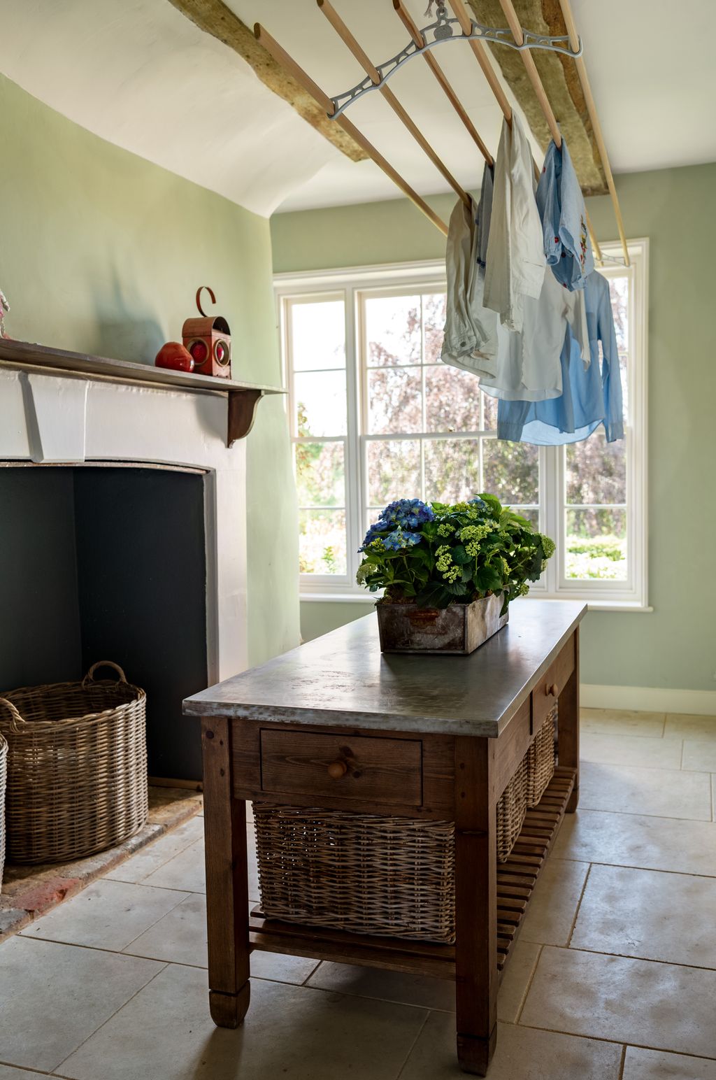 Image may contain Indoors Interior Design Floor Wood Basket Flower Flower Arrangement Plant Furniture and Table