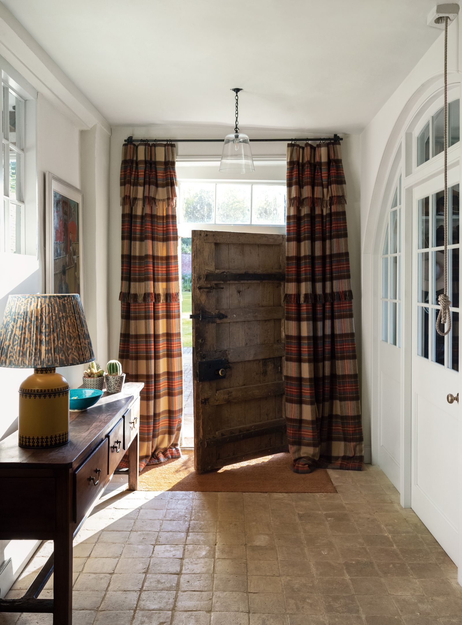 Image may contain Lamp Door Indoors Interior Design Home Decor Rug Architecture Building Housing and Table Lamp