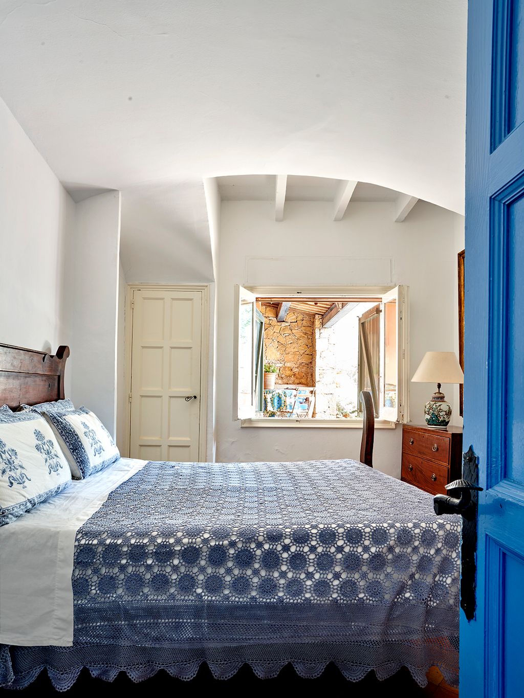 Image may contain Lamp Bed Furniture Plant Indoors Interior Design Bedroom Room Chair and Home Decor