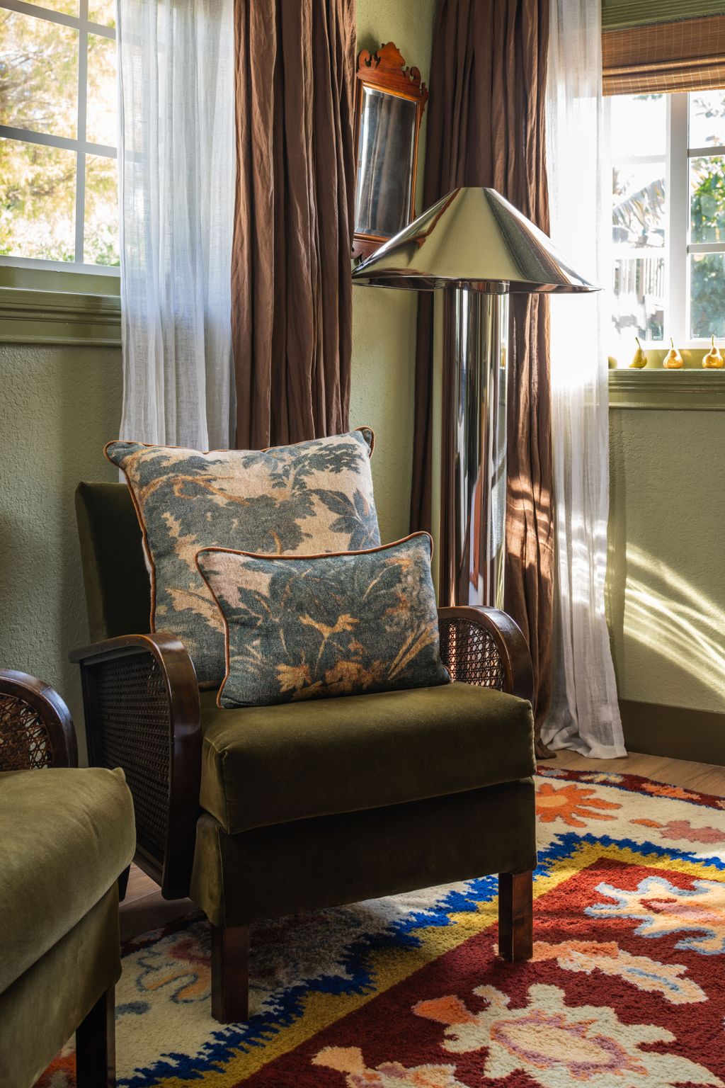 Image may contain Home Decor Furniture Chair Lamp Rug and Armchair