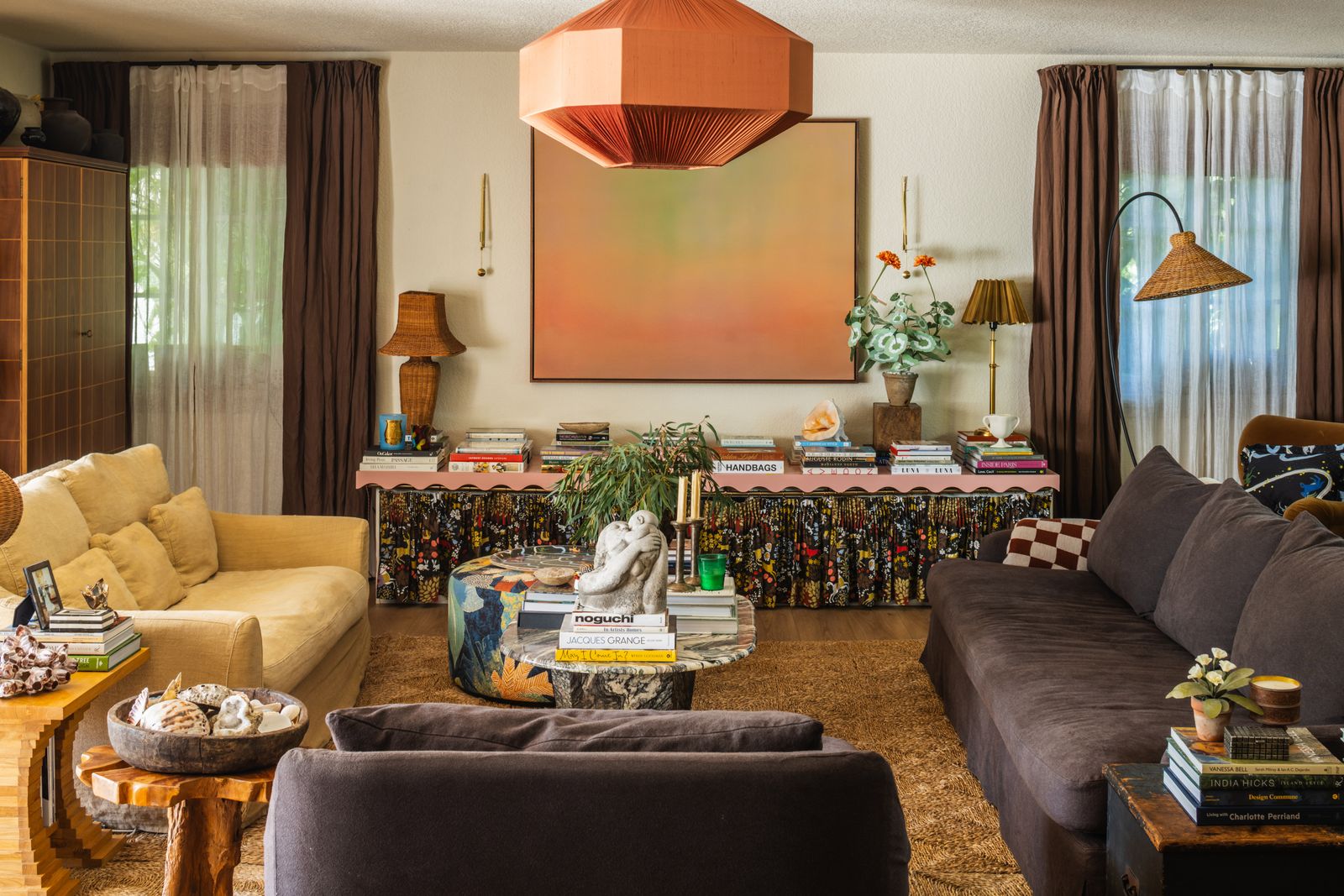 Image may contain Home Decor Lamp Couch Furniture Architecture Building Indoors Living Room Room Table and Person