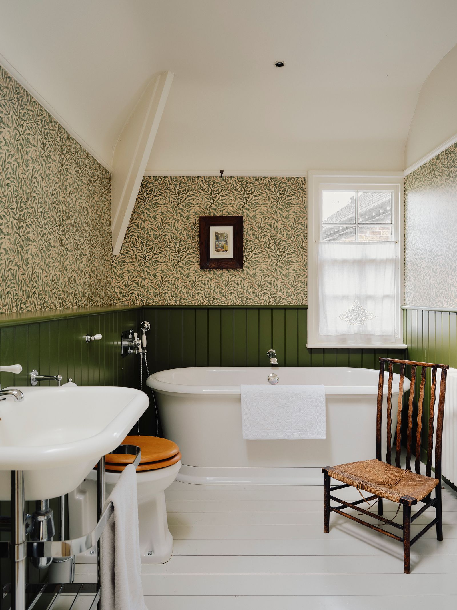 Image may contain Chair Furniture Sink Bathing Indoors Interior Design Tub Art Painting Bathtub and Person