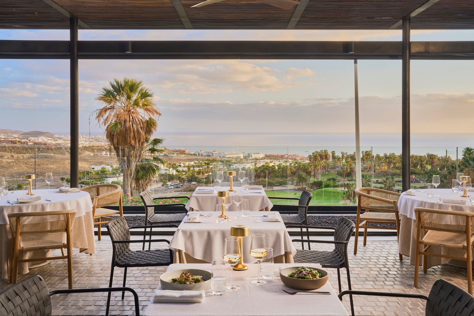 Image may contain Furniture Table Chair Dining Table Indoors Cutlery Fork Architecture Building and Dining Room